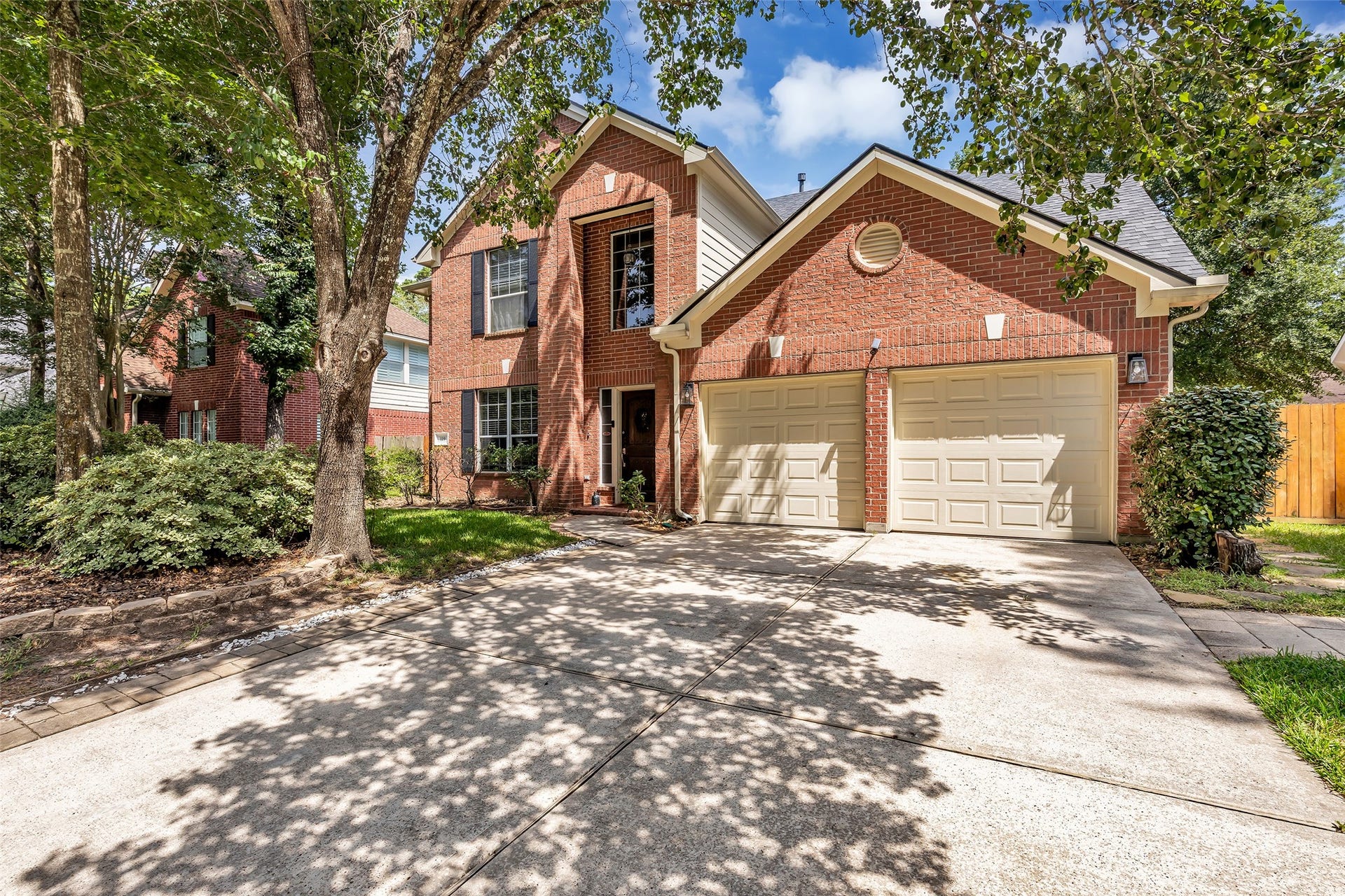 119 N Westwinds Circle, The Woodlands, TX 77382 Nice double-wide driveway with two-car garage with workbench.