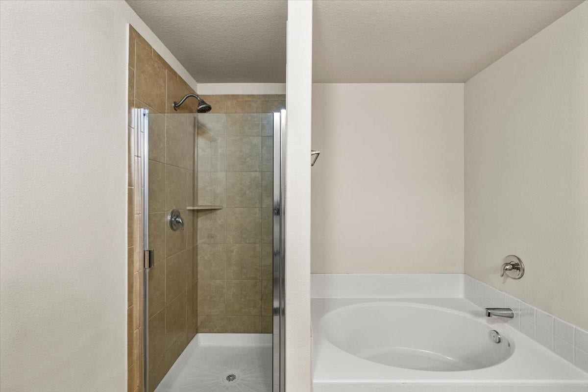 422 Hawks View Drive, La Marque, TX 77568 Primary bathroom with tub and stand up shower