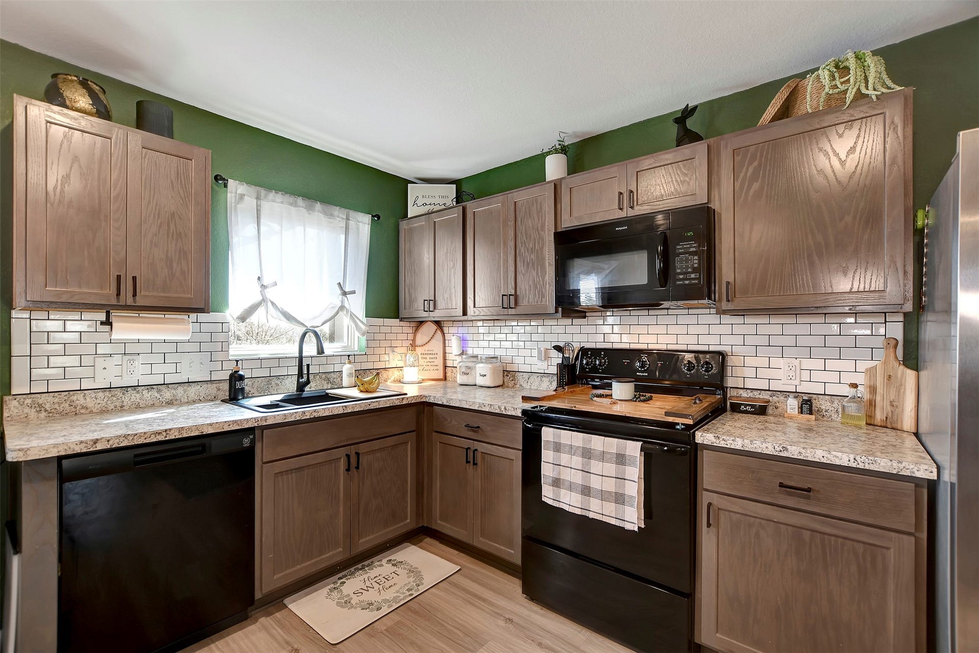Beautiful kitchen featuring upgraded backsplash, abundant cabinetry for storage, and a functional layout ideal for cooking and entertaining.