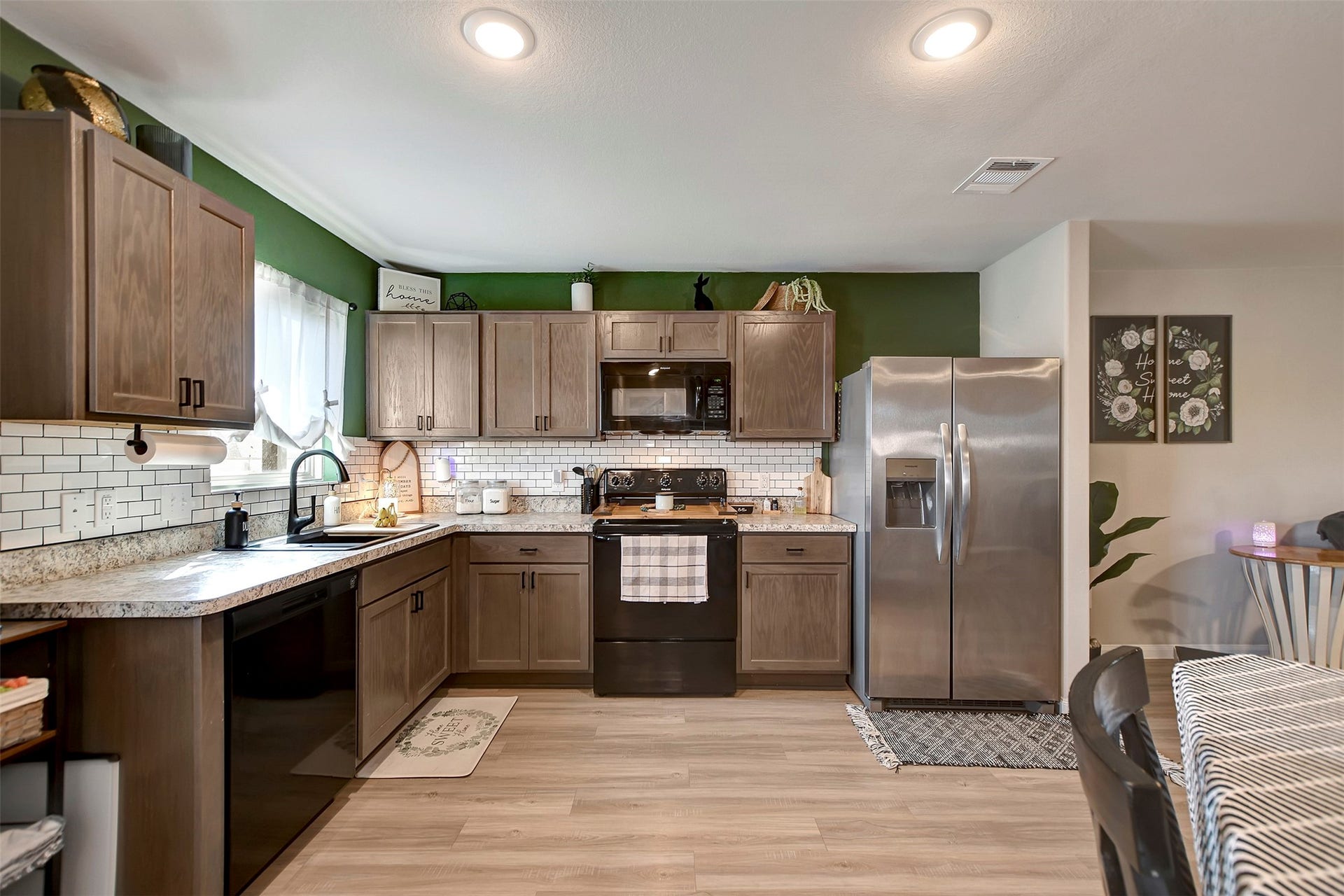 Beautiful kitchen featuring upgraded backsplash, abundant cabinetry for storage, and a functional layout ideal for cooking and entertaining.