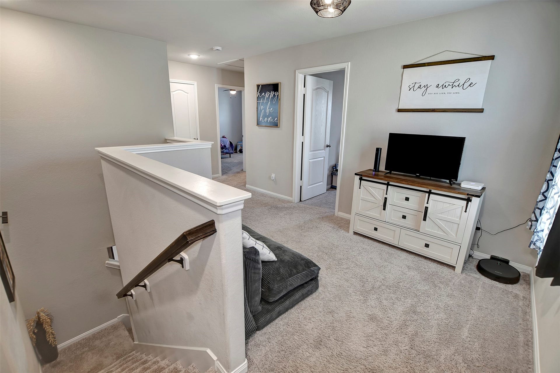 Versatile upstairs loft perfect for a second living area, game room, or home office.