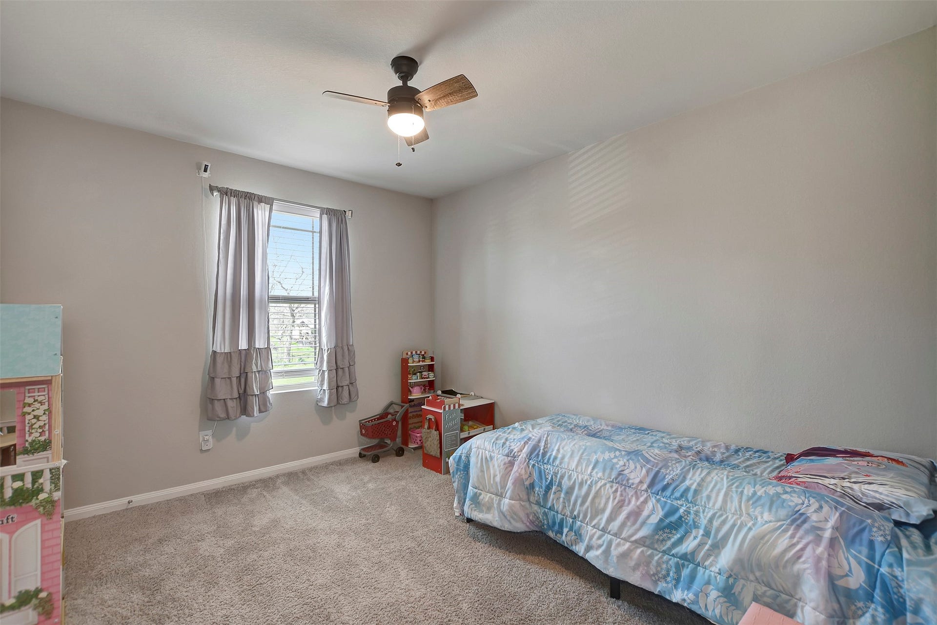 Comfortable secondary bedroom with ample natural light and closet space.
