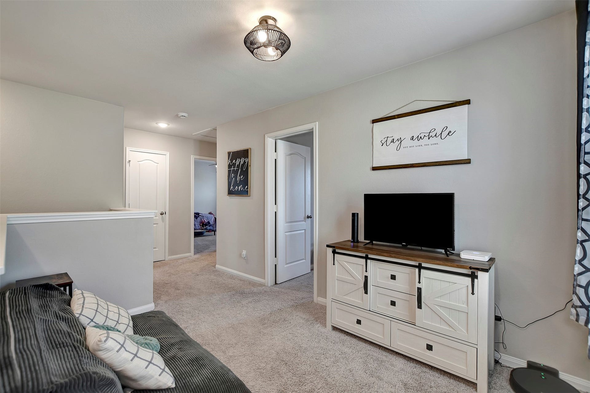 Versatile upstairs loft perfect for a second living area, game room, or home office.