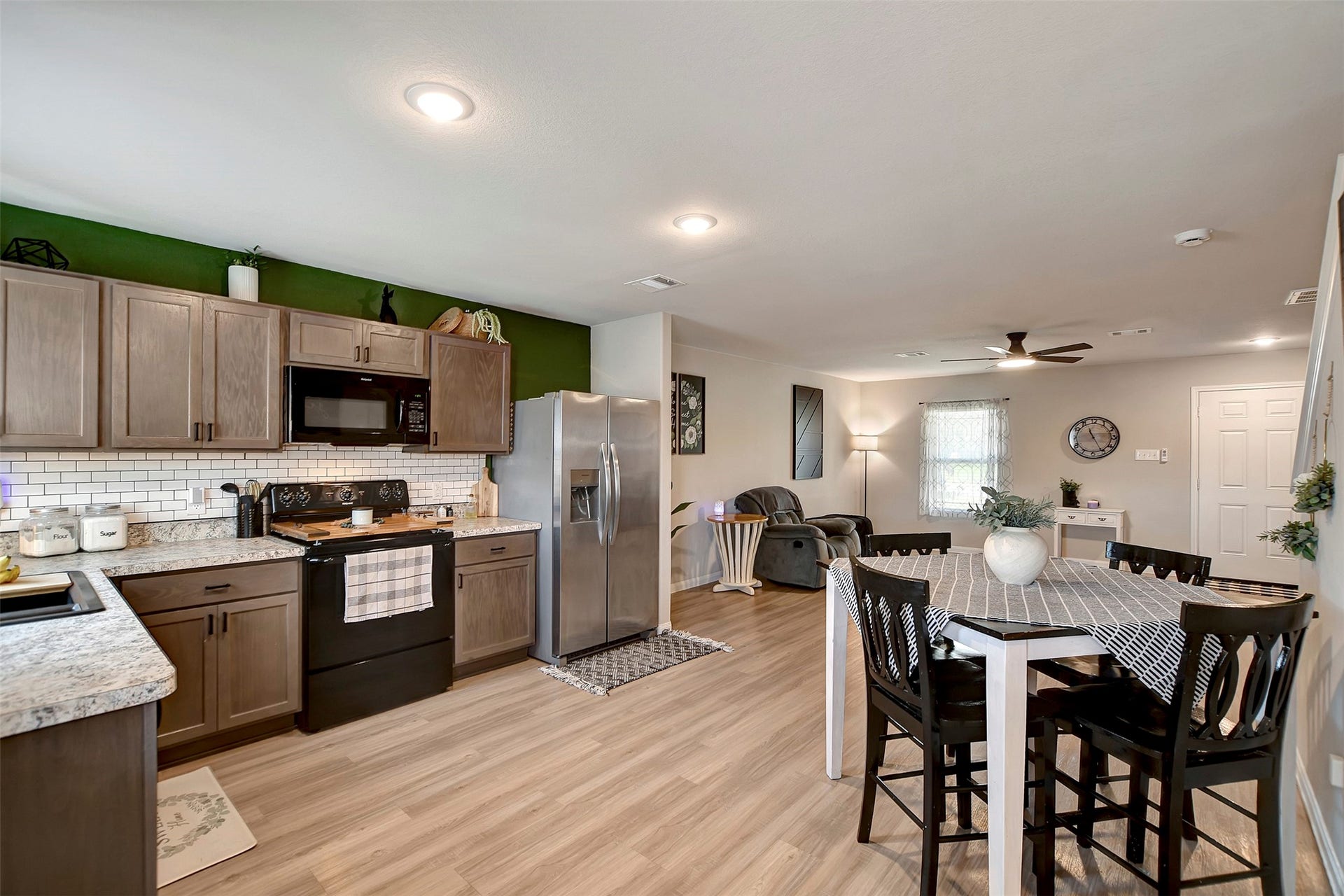 Beautiful kitchen featuring upgraded backsplash, abundant cabinetry for storage, and a functional layout ideal for cooking and entertaining.