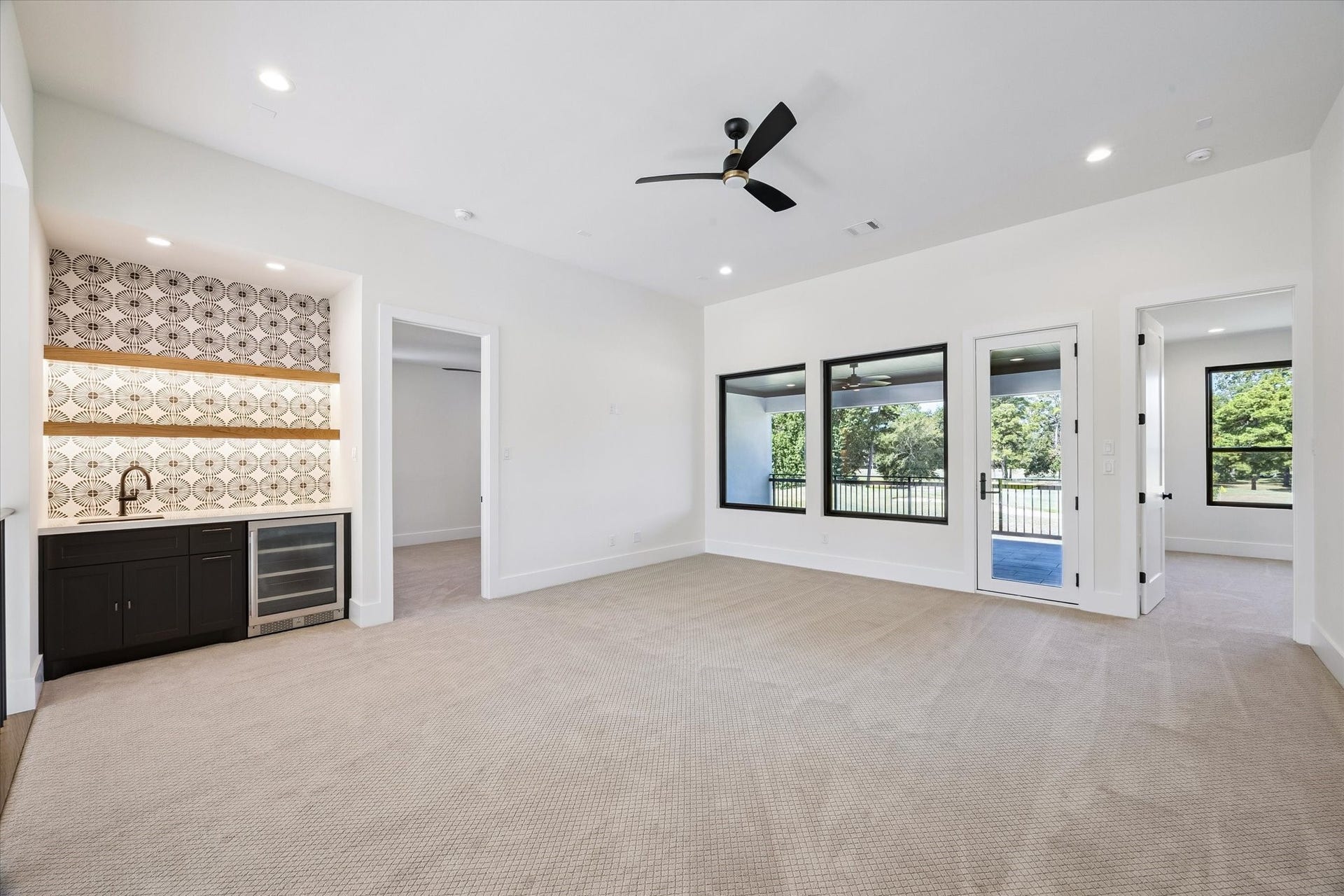 65 Shadow Creek Ridge Drive, Spring, TX 77389 Bright game room with built-in wet bar, designer backsplash, and balcony access through glass doors.