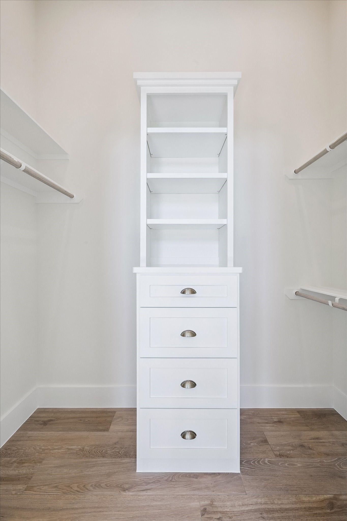 65 Shadow Creek Ridge Drive, Spring, TX 77389 Custom walk-in closet shines with built-in drawers, open shelving, and double hanging rods.