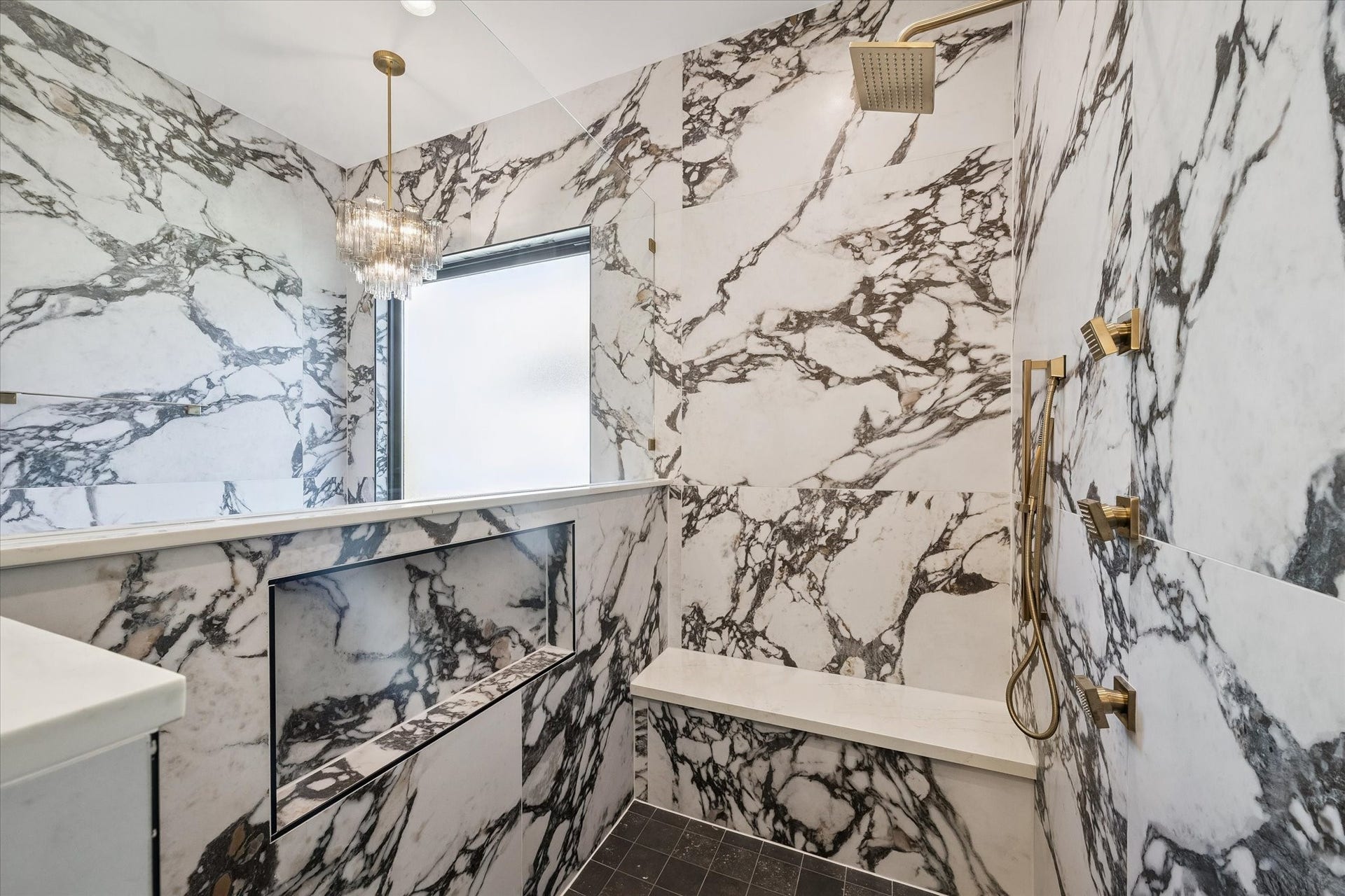 65 Shadow Creek Ridge Drive, Spring, TX 77389 A frameless glass shower pairs beautifully with brushed gold fixtures, including a rain showerhead and handheld sprayer for options that suit every mood.