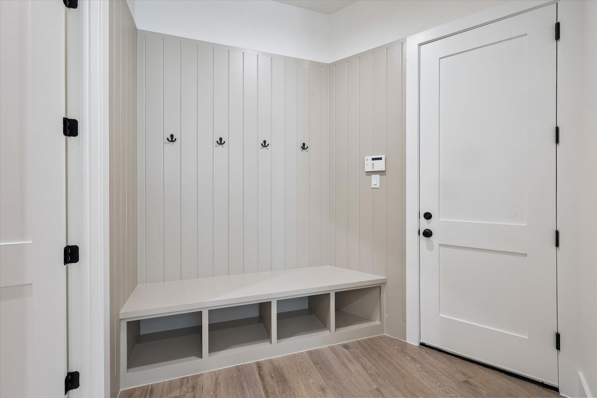 65 Shadow Creek Ridge Drive, Spring, TX 77389 Stylish mudroom entry with built-in bench, open cubbies, and shiplap wall with coat hooks.