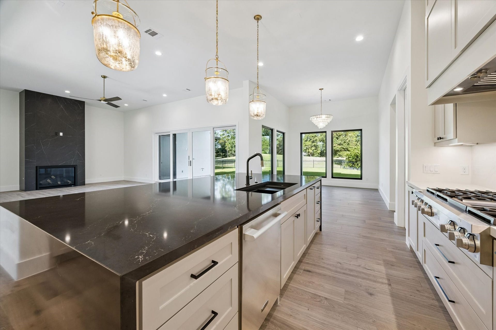 65 Shadow Creek Ridge Drive, Spring, TX 77389 Three statement pendant lights add sparkle overhead, and the built-in double wall ovens and walk-in pantry nearby make hosting feel almost effortless.