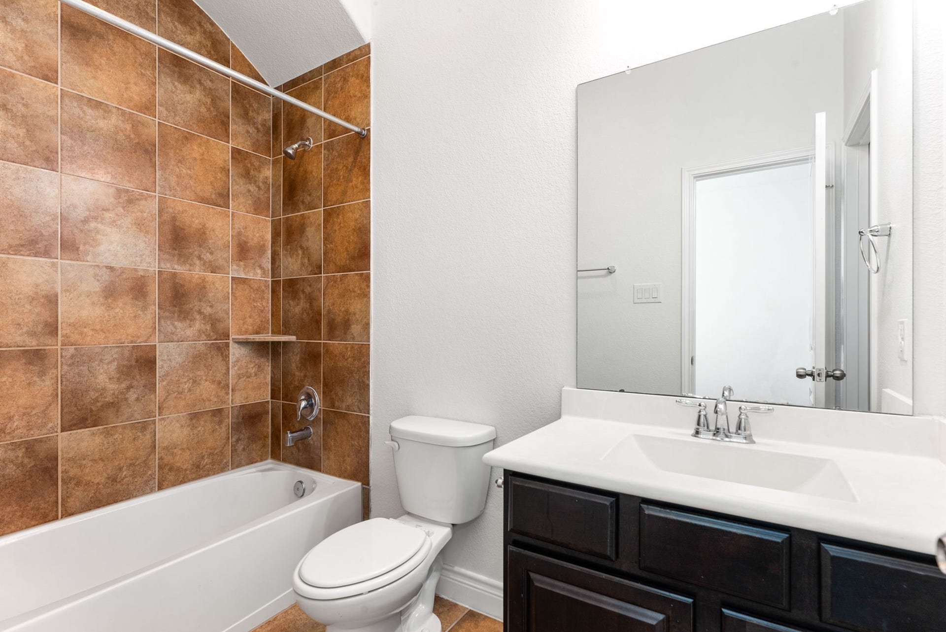 3318 Elizabeth Springs Court, Katy, TX 77494 Secondary bathroom with stylish vanity, tub/shower combination, and designer tile surround.