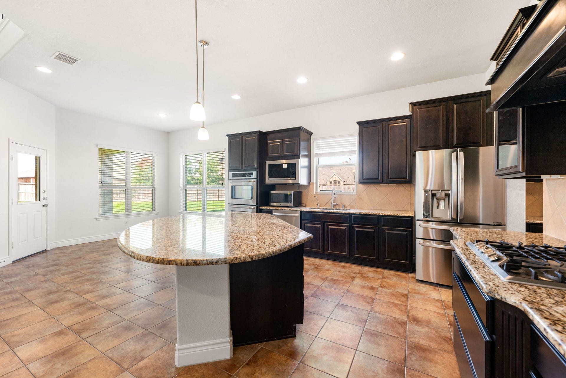 3318 Elizabeth Springs Court, Katy, TX 77494 Large kitchen island and breakfast area are a chef and family's delight.
