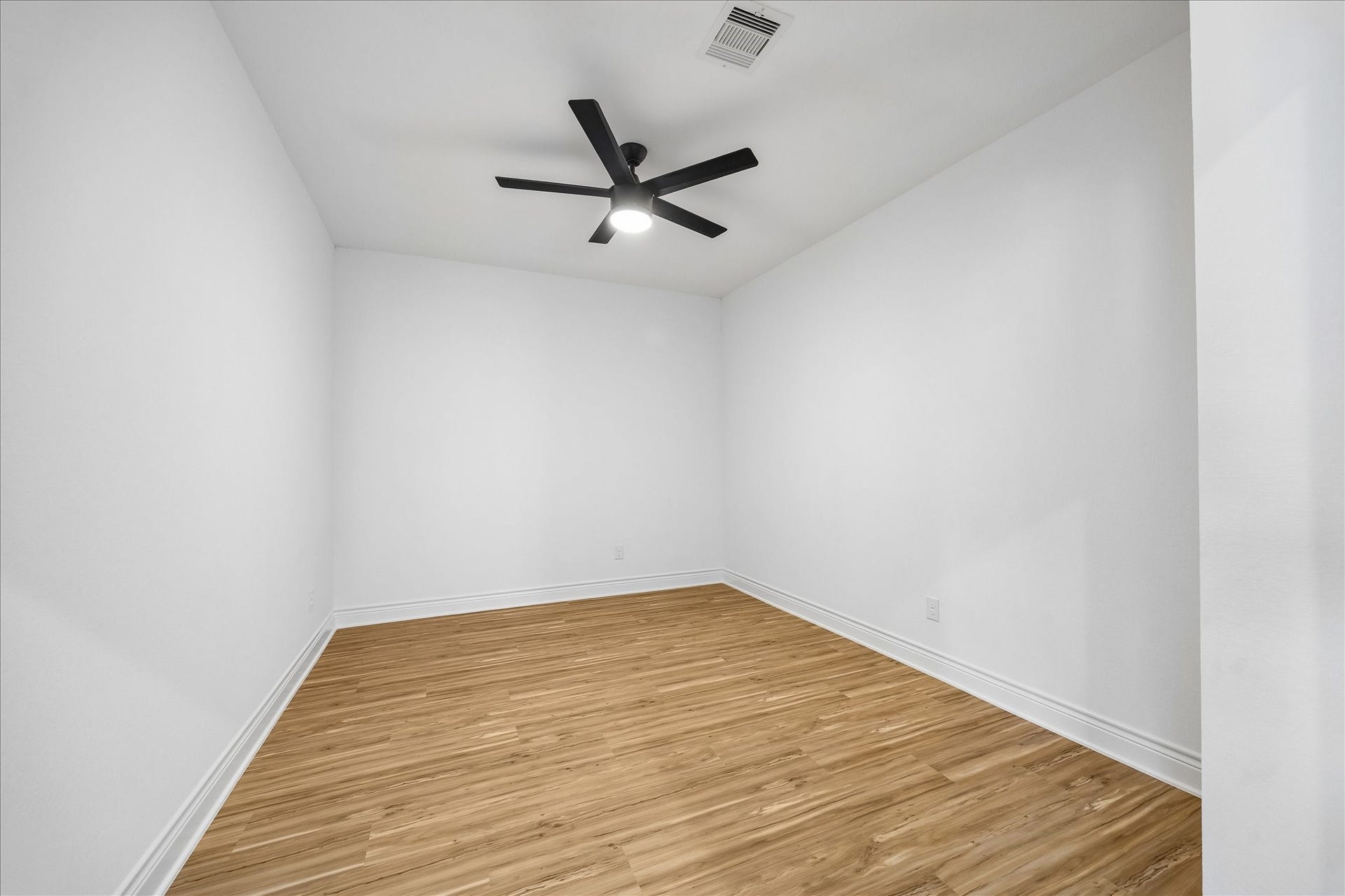 Dedicated media room offering the perfect space for movie nights, game days, or a versatile hobby room tailored to your interests.