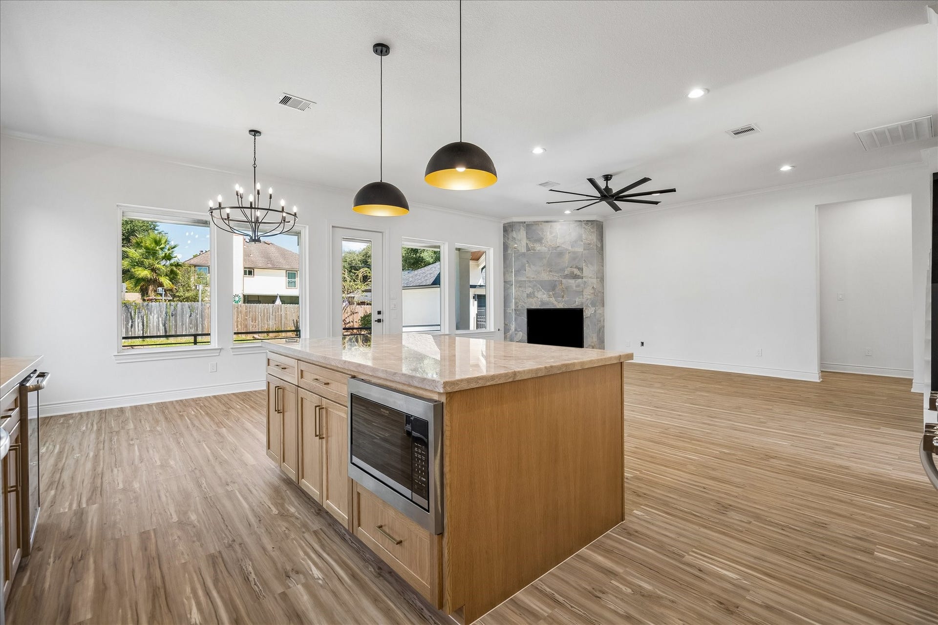 Spacious open-concept design seamlessly connecting the kitchen, family room, and breakfast area, creating an inviting space perfect for everyday living and entertaining.