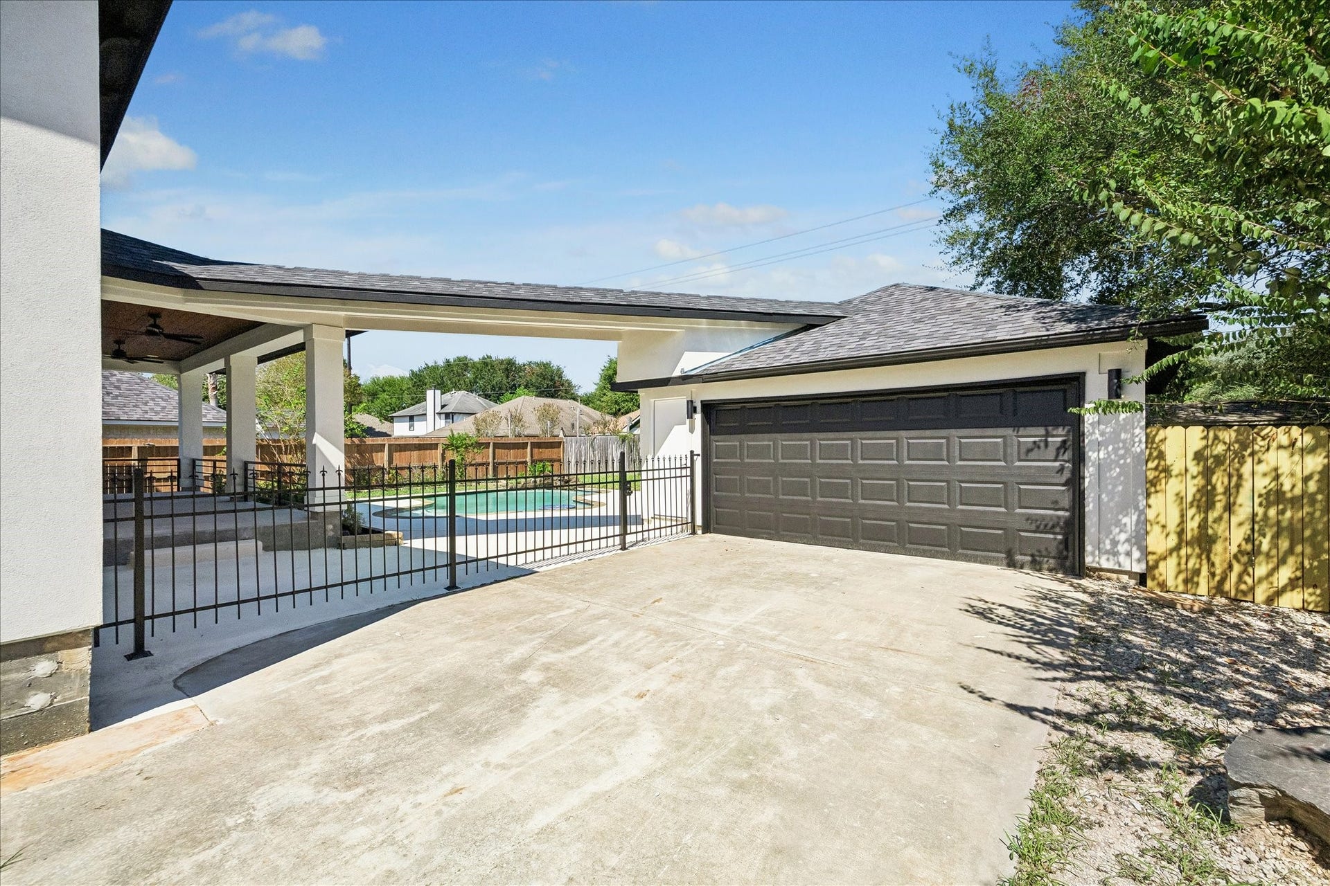The pre-existing garage has been updated to compliment the new homes exterior. The garage interior is newly sheetrocked and a brand new wrought iron breezeway fence was added.