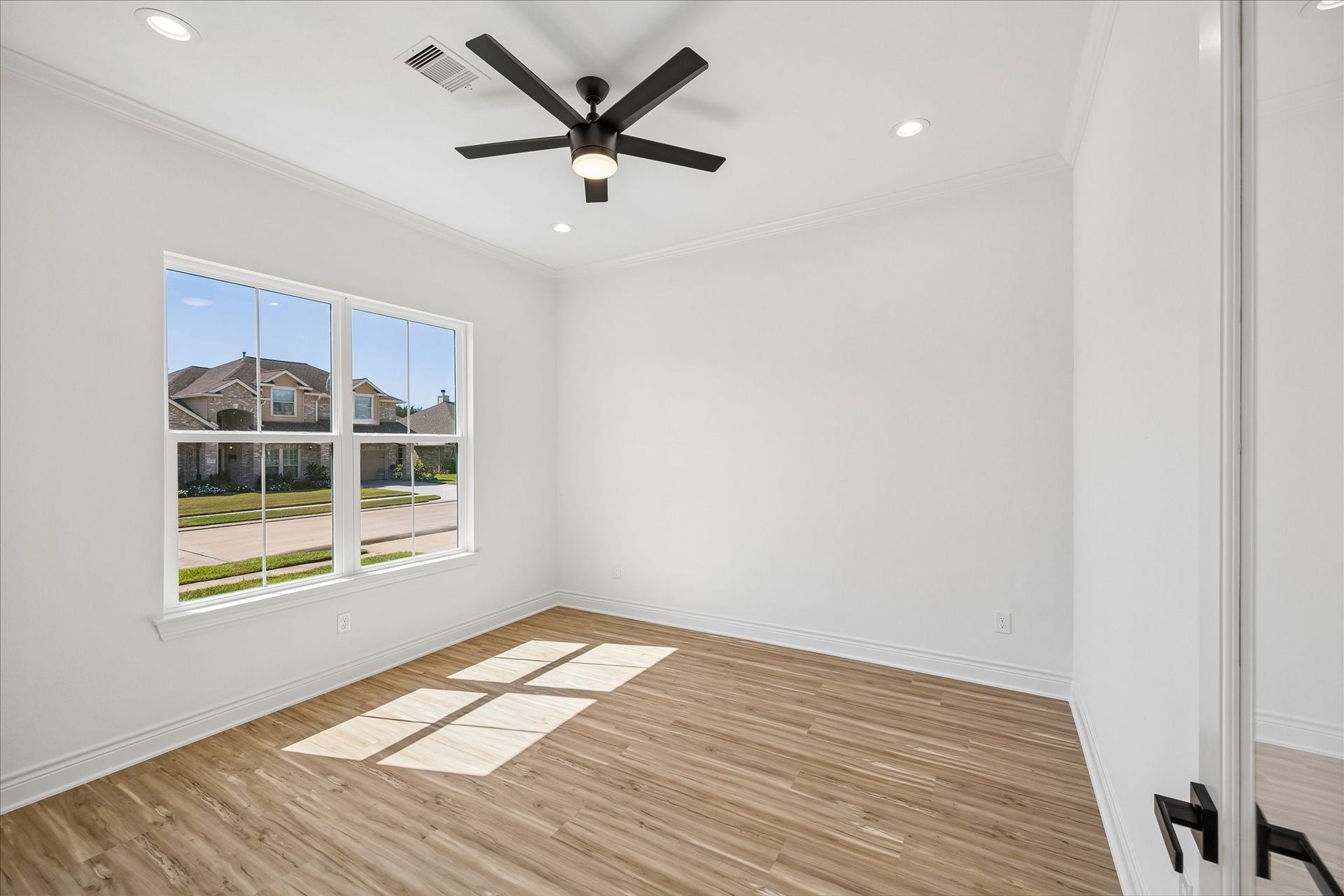 A spacious study featuring 8 foot french doors creating an ideal space a private home office.