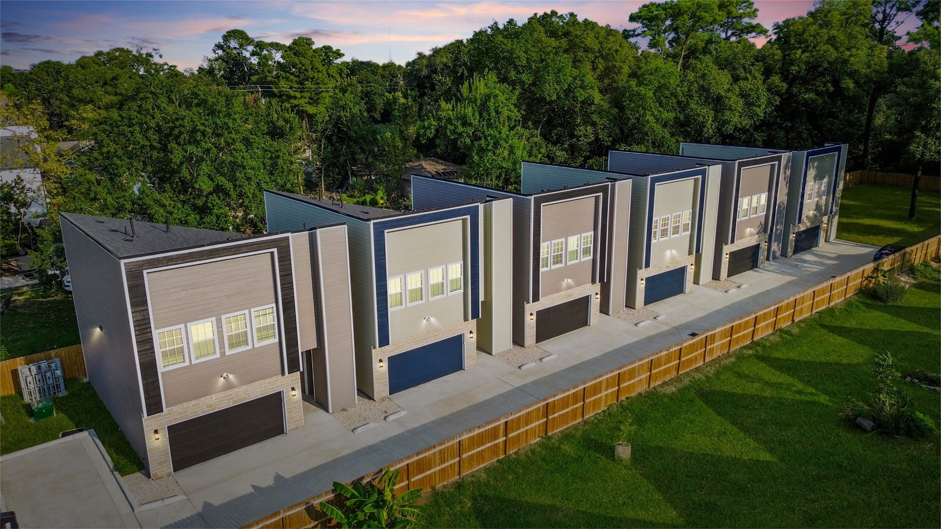 825 Paul Quinn Street, #B, Houston, TX 77091 From above, you can see the striking row of modern townhomes, each with bold architectural lines and stylish exteriors. The clean, uniform design makes the community feel contemporary and cohesive, while the private fenced backdrop ensures both privacy and peace.