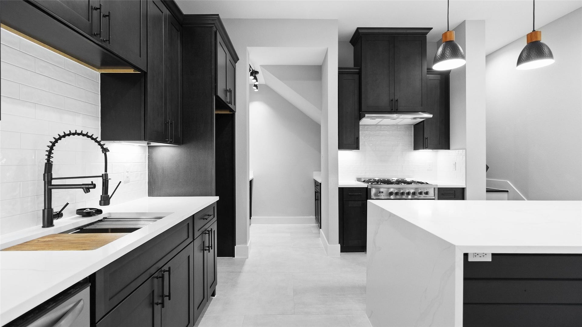 825 Paul Quinn Street, #B, Houston, TX 77091 Cooking feels effortless with the sleek navy cabinetry, gold fixtures, and plenty of counter space to spread out and create.