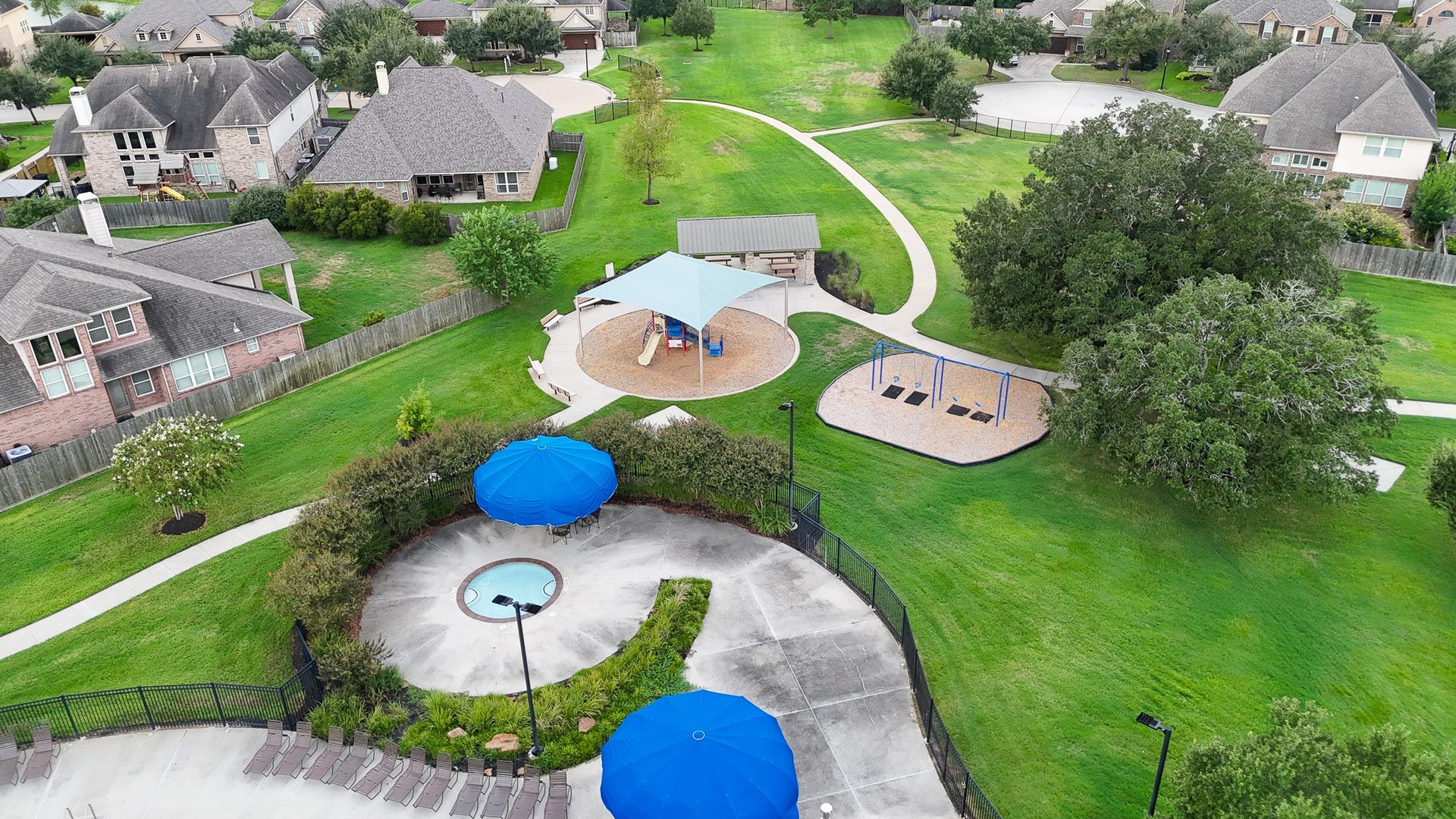 12218 Rampy Green Drive, Tomball, TX 77377 View of kiddie pool, playground, and picnic area.