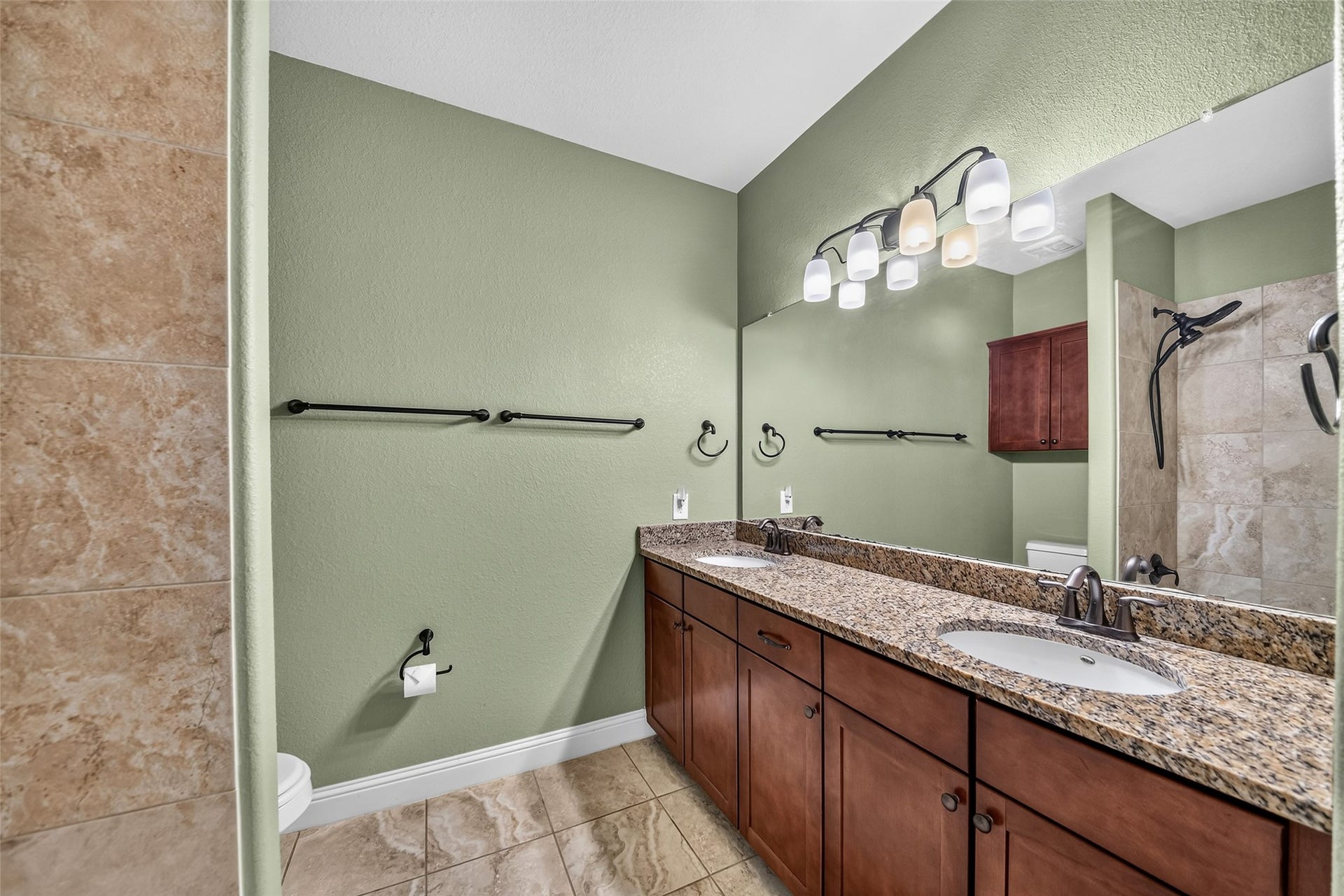 12218 Rampy Green Drive, Tomball, TX 77377 Elegant second full bathroom featuring a double sinks with granite countertops.