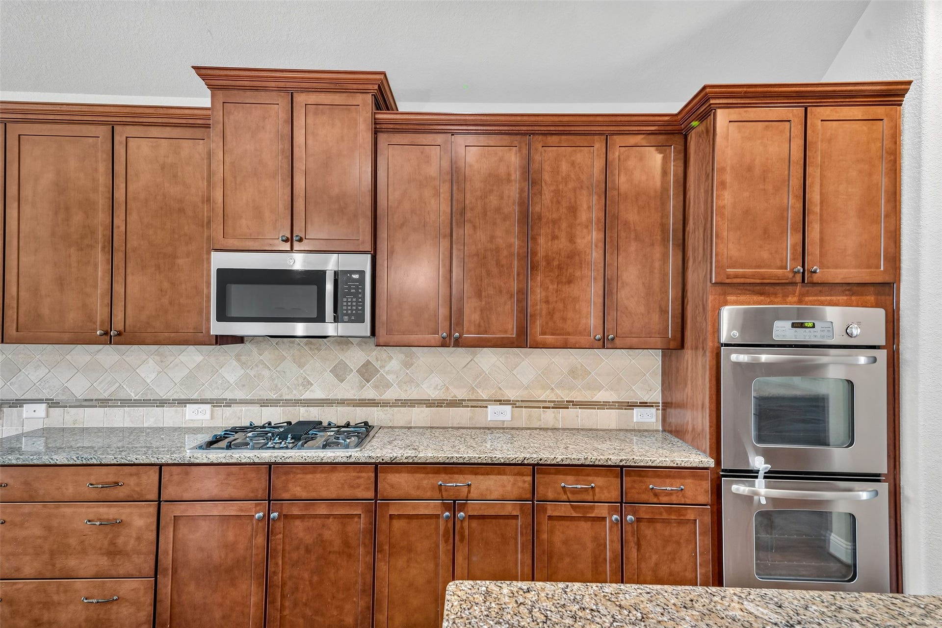 12218 Rampy Green Drive, Tomball, TX 77377 Stainless steel appliances and ample storage, including a built-in microwave and a double oven for your cooking convenience.