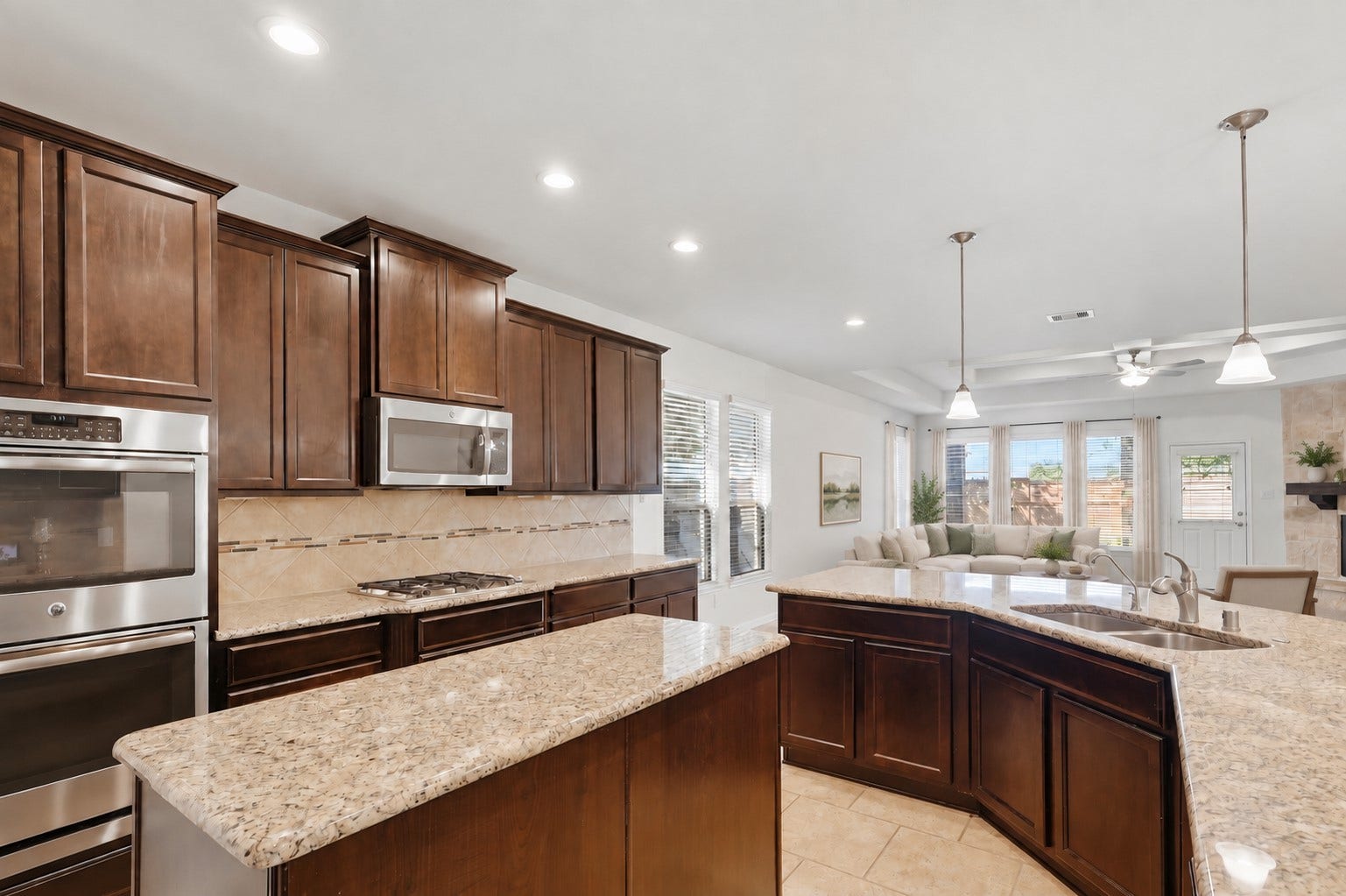11723 Giovanni Lane, Richmond, TX 77406 A Kitchen Any Cook Will Appreciate! This fabulous gourmet kitchen offers rich custom cabinetry, beautiful granite countertops, a generous breakfast bar, stainless steel appliances, and plenty of workspace. The open design connects beautifully with the casual dining and family room, making everyday living and entertaining wonderfully easy. *Photo is virtually staged*