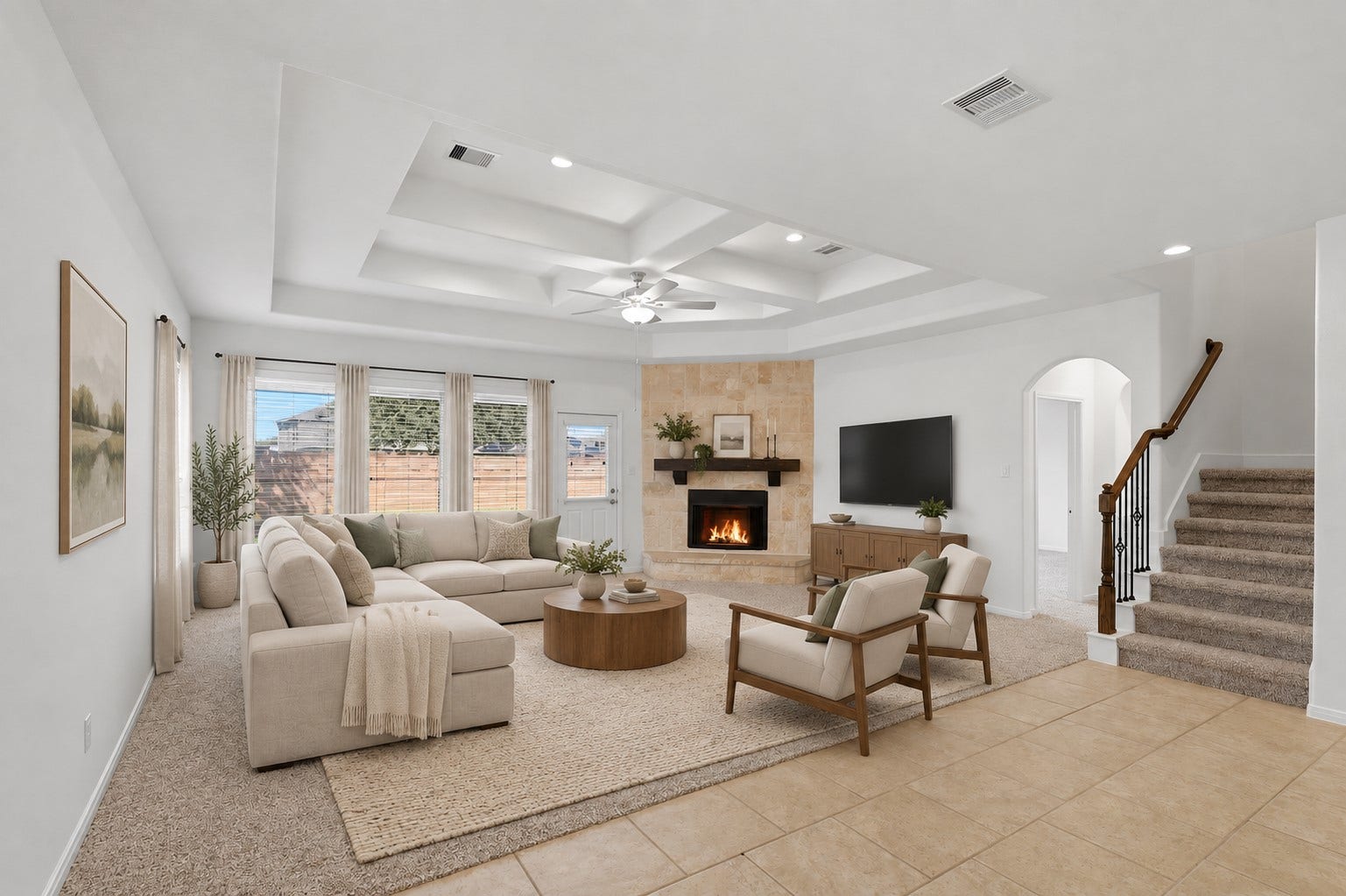 11723 Giovanni Lane, Richmond, TX 77406 A Beautiful View of the Open Living Space! From this perspective, you can really appreciate the spacious family room, soaring custom ceiling details, stone fireplace, and wall of windows bringing in beautiful natural light. The staircase adds an elegant architectural touch, while the open connection to the kitchen keeps the entire space feeling wonderfully connected. *Photo is virtually staged*