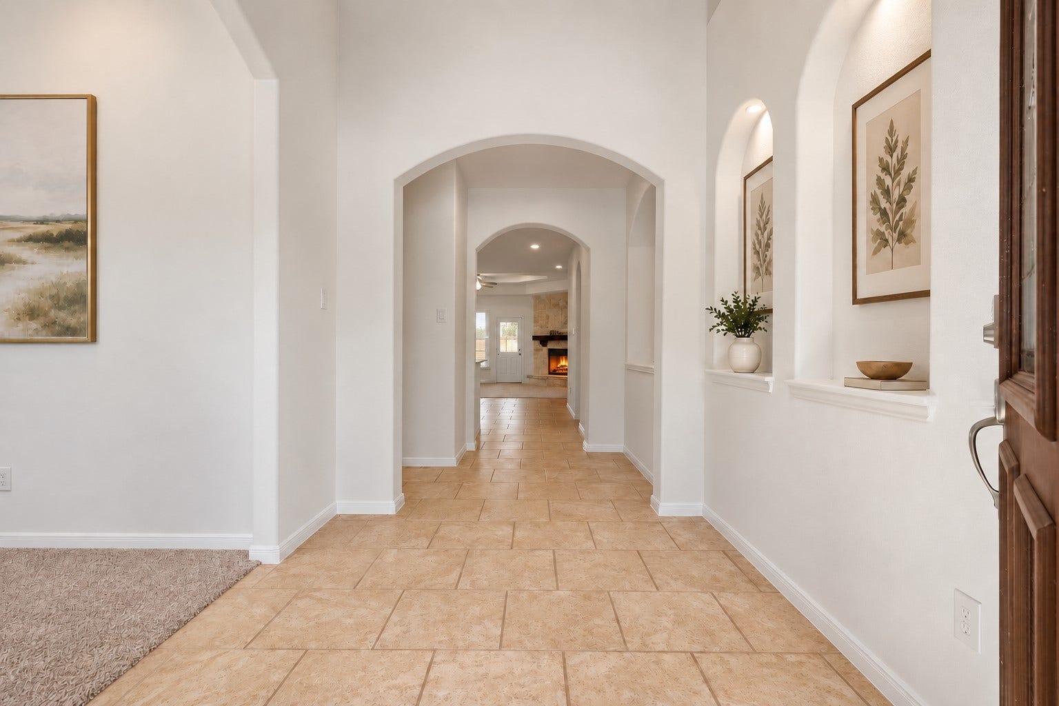 11723 Giovanni Lane, Richmond, TX 77406 Elegant Details Around Every Corner! This lovely entry hallway showcases high ceilings, beautiful tile flooring, graceful arches, and charming lighted art niches. The long, welcoming hallway creates a wonderful flow through the home while giving you pretty glimpses of the living spaces beyond. Bright, open, and beautifully finished! *Photo is virtually staged*
