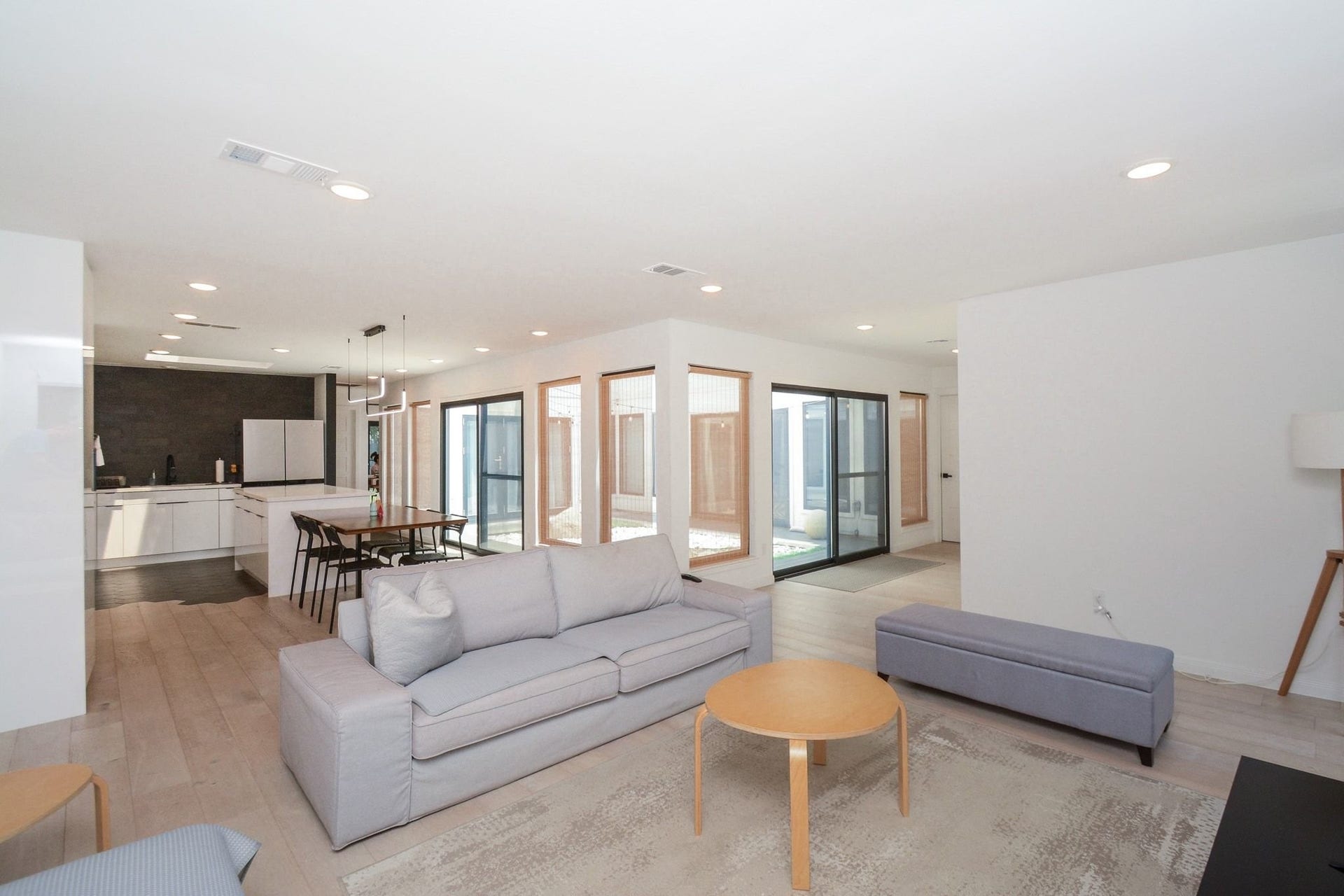 Open living area featuring contemporary finishes, abundant natural light, and seamless flow to dining space.