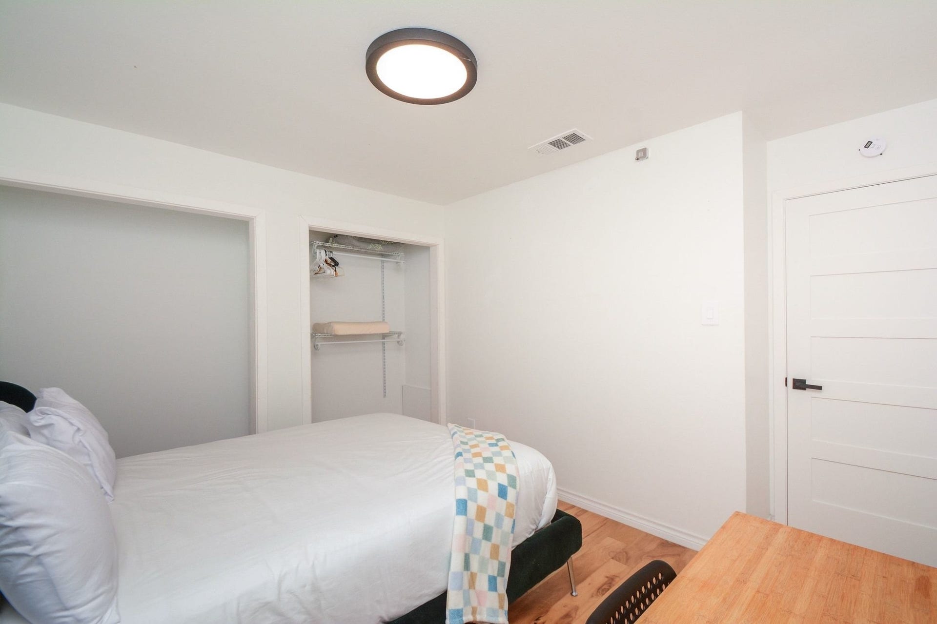 Comfortable bedroom with updated flooring, recessed lighting, and ample closet space. 2nd Bedroom