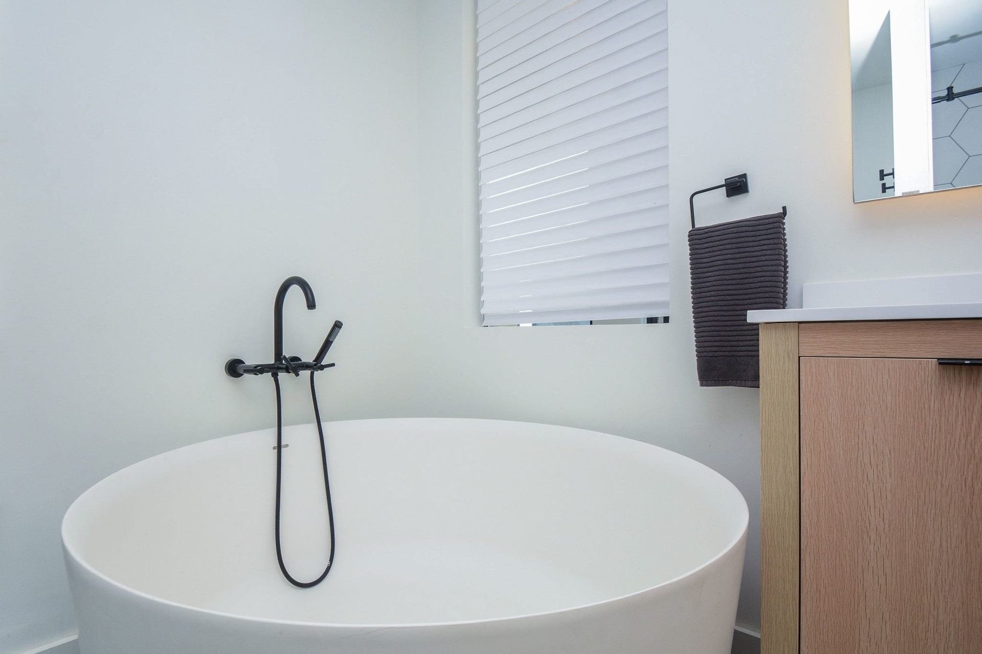 Primary bathroom showcasing a stylish freestanding tub, modern fixtures, and contemporary design.