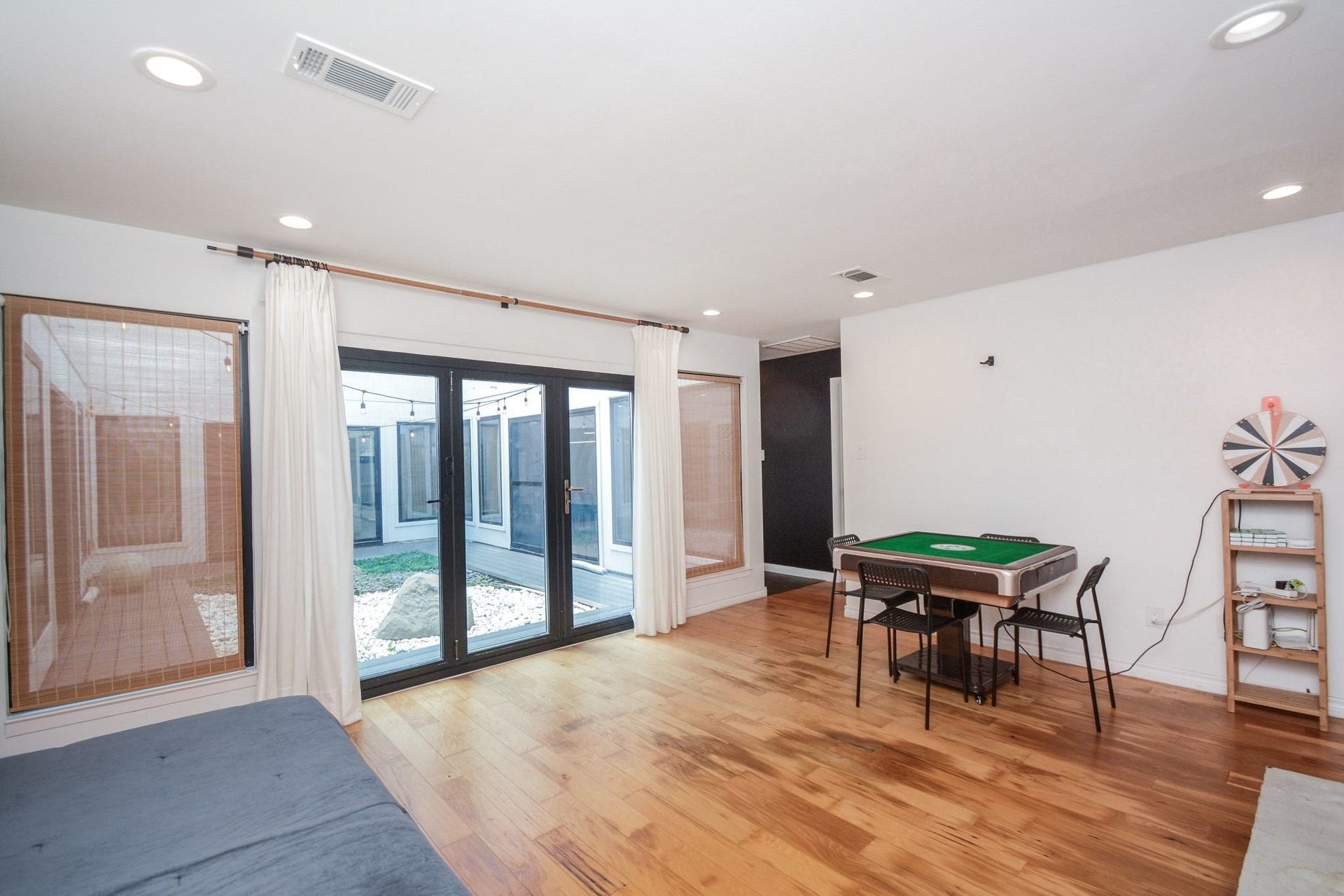 Spacious open game room with updated flooring and abundant natural light.