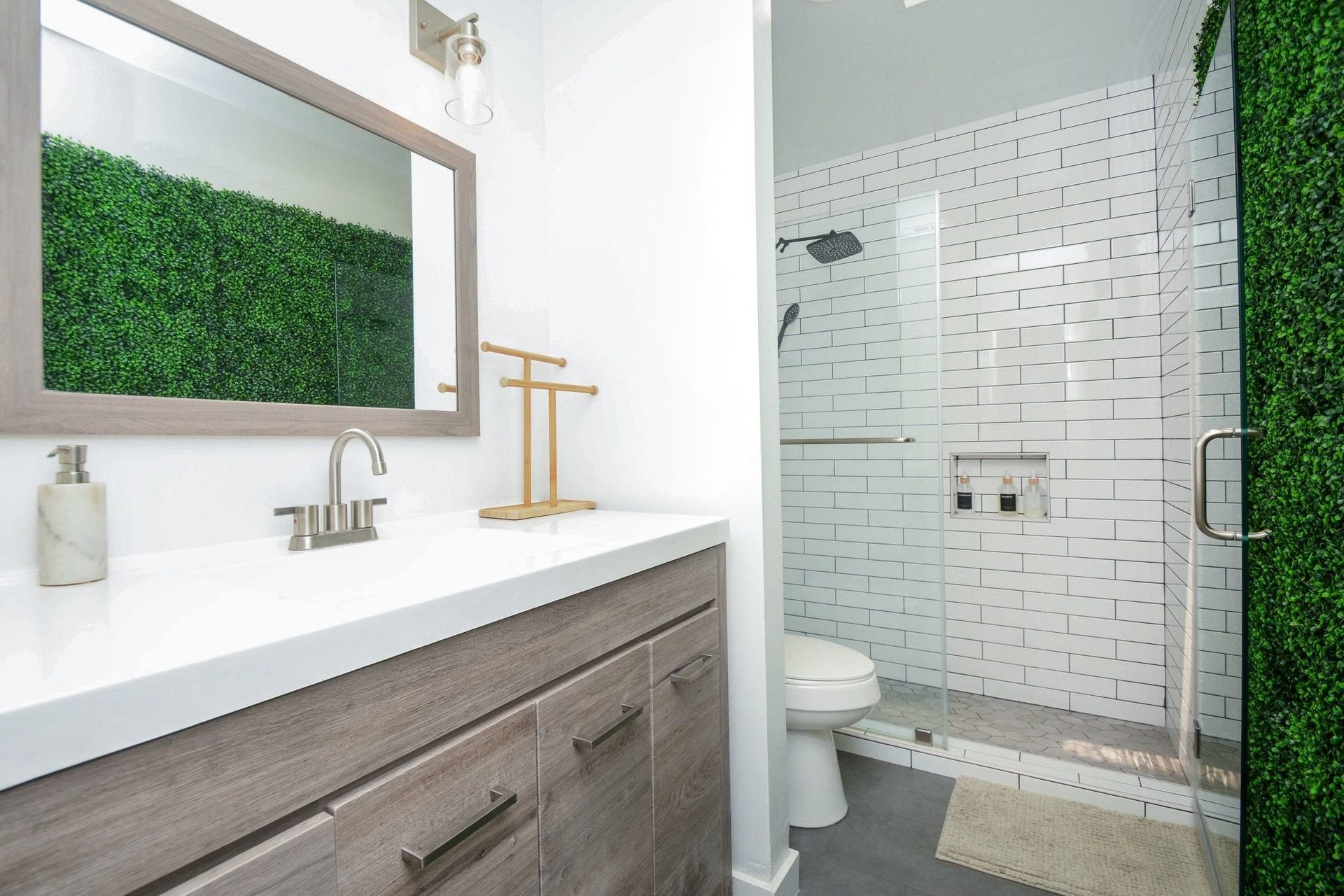 Stylish bathroom with modern vanity, large mirror, and updated walk-in shower.