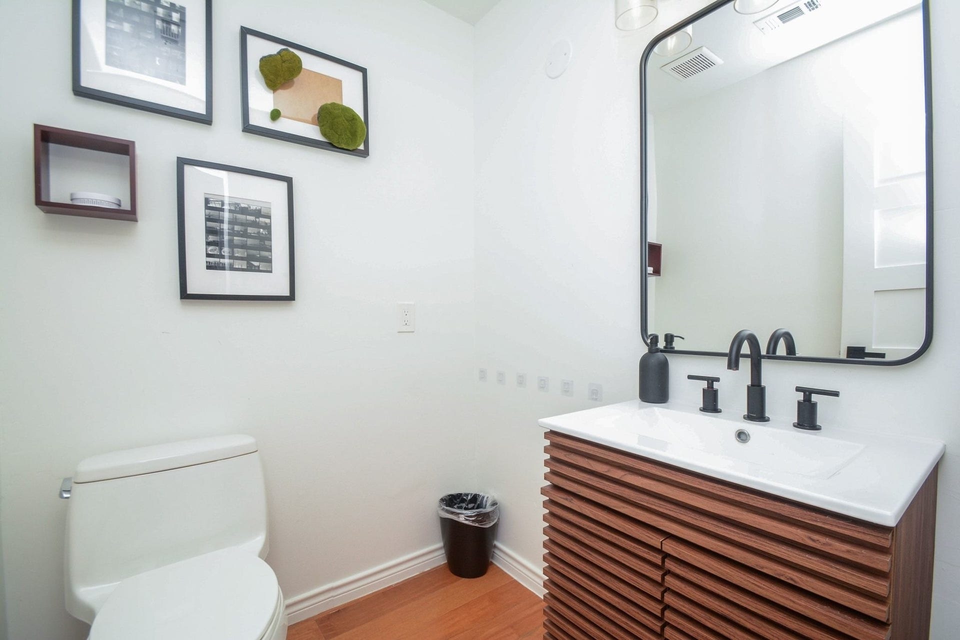 Updated hallway bathroom area featuring modern vanity, contemporary fixtures, and stylish finishes.
