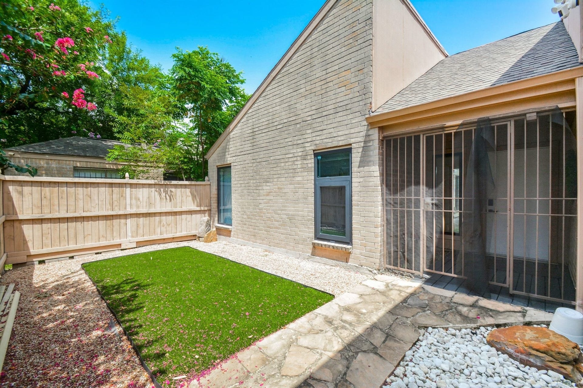 Attractive rear exterior with private courtyard and covered outdoor living area.