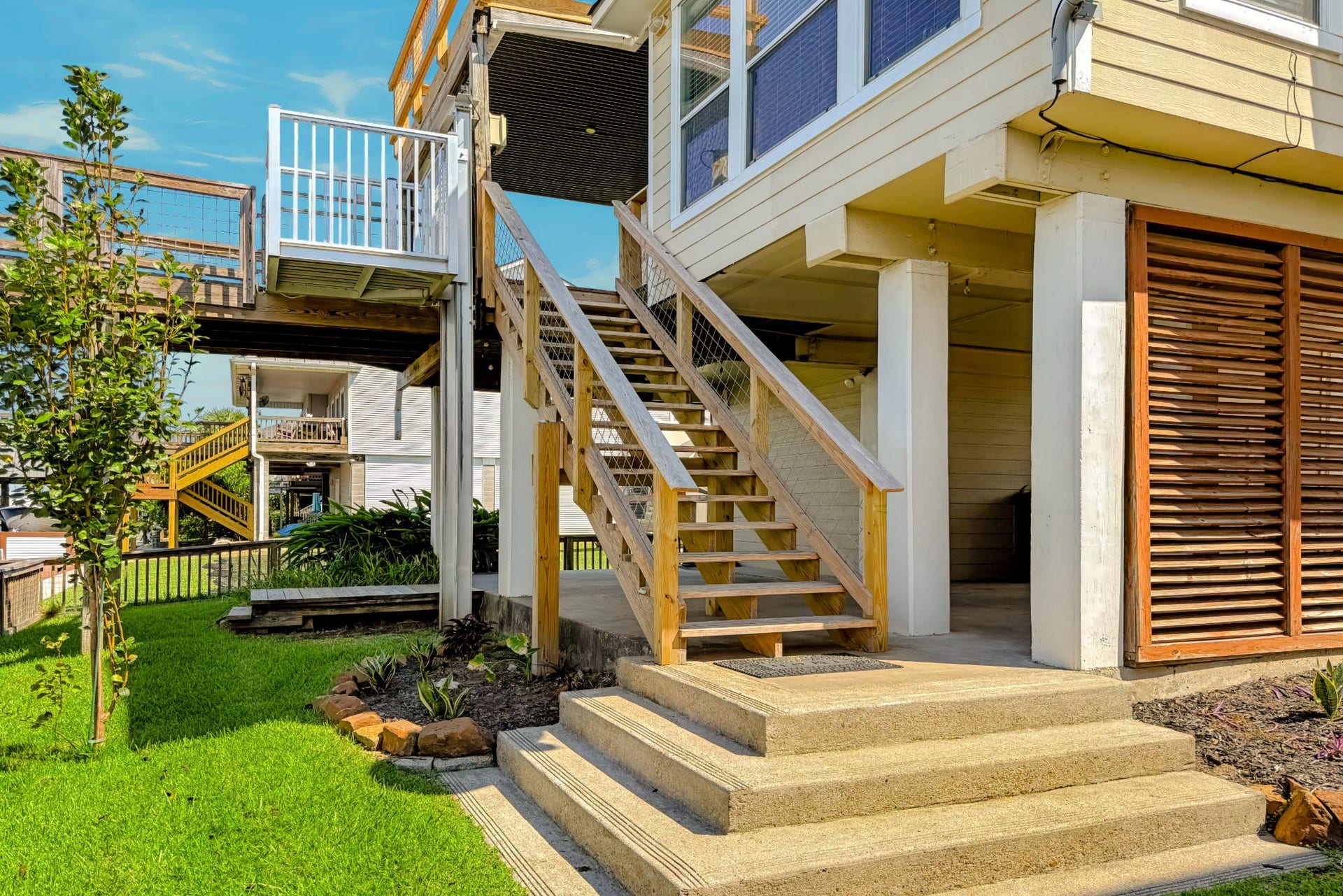 1144 Sailfish Street, Bayou Vista, TX 77563 AMAZING CONCRETE STEPS AT BOTTOM OF BACK STAIRS ON CANAL SIDE OF HOME