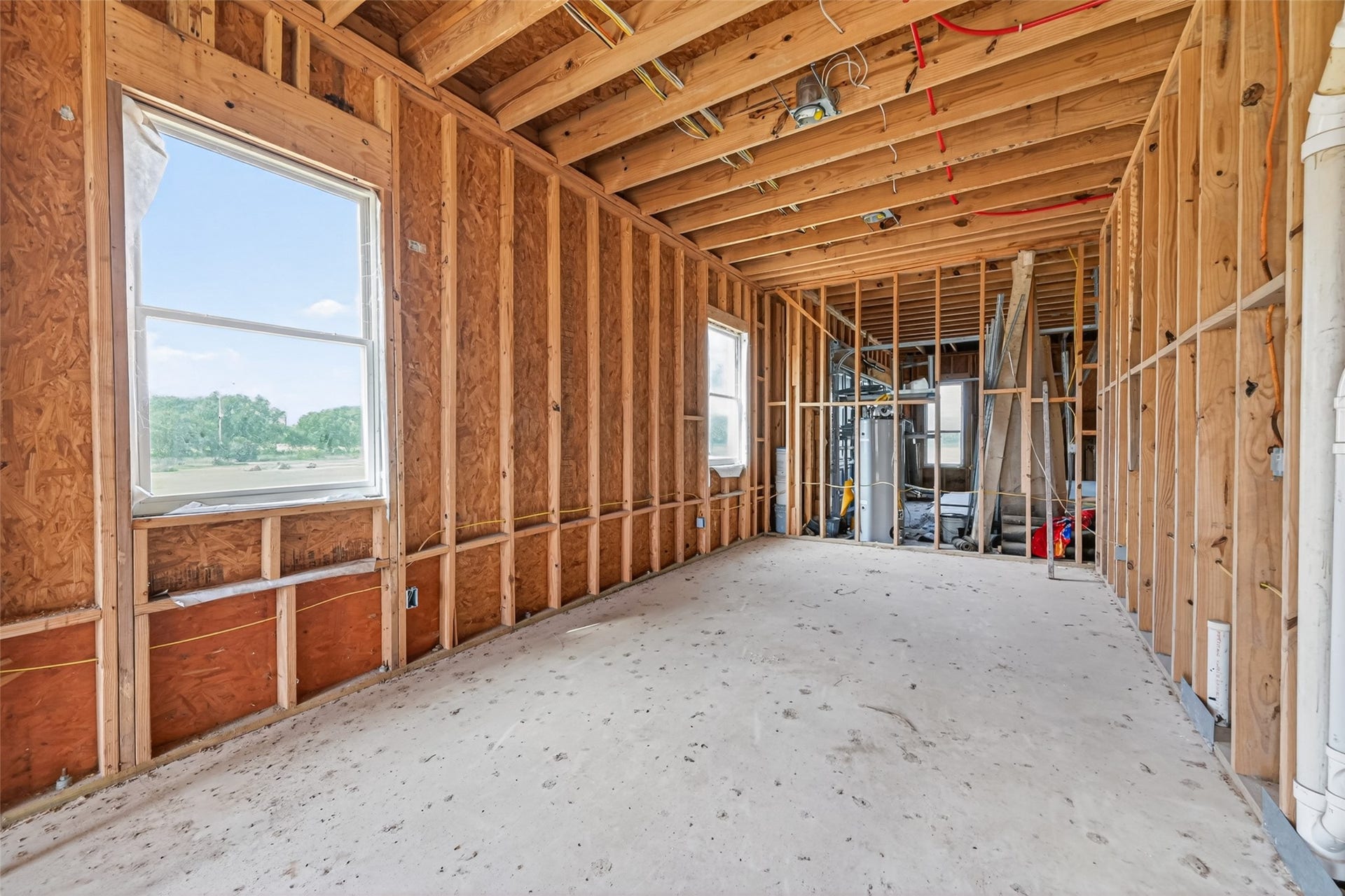 8023 Pool Hill Road, Fulshear, TX 77441 Open unfinished space showcasing framing and build progress.