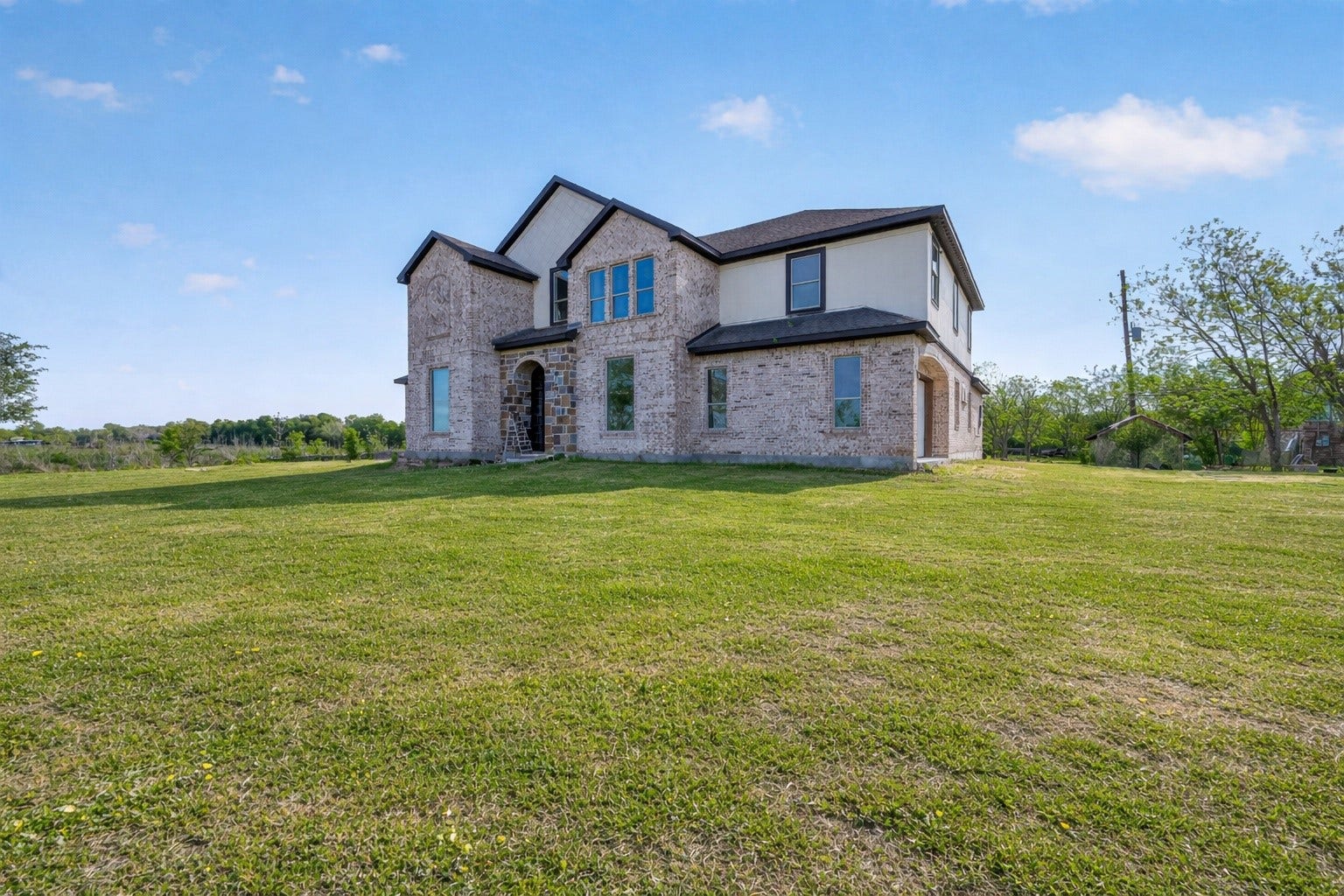 8023 Pool Hill Road, Fulshear, TX 77441 Property 1 unfinished residence with virtually enhanced lawn for outdoor potential.