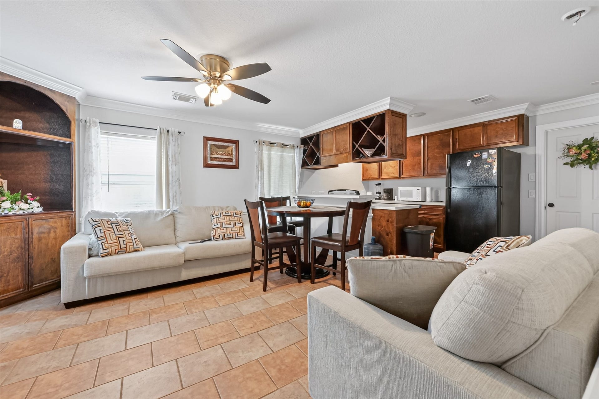 8023 Pool Hill Road, Fulshear, TX 77441 Second-level living area featuring open-concept layout, tile flooring, and adjacent kitchen.