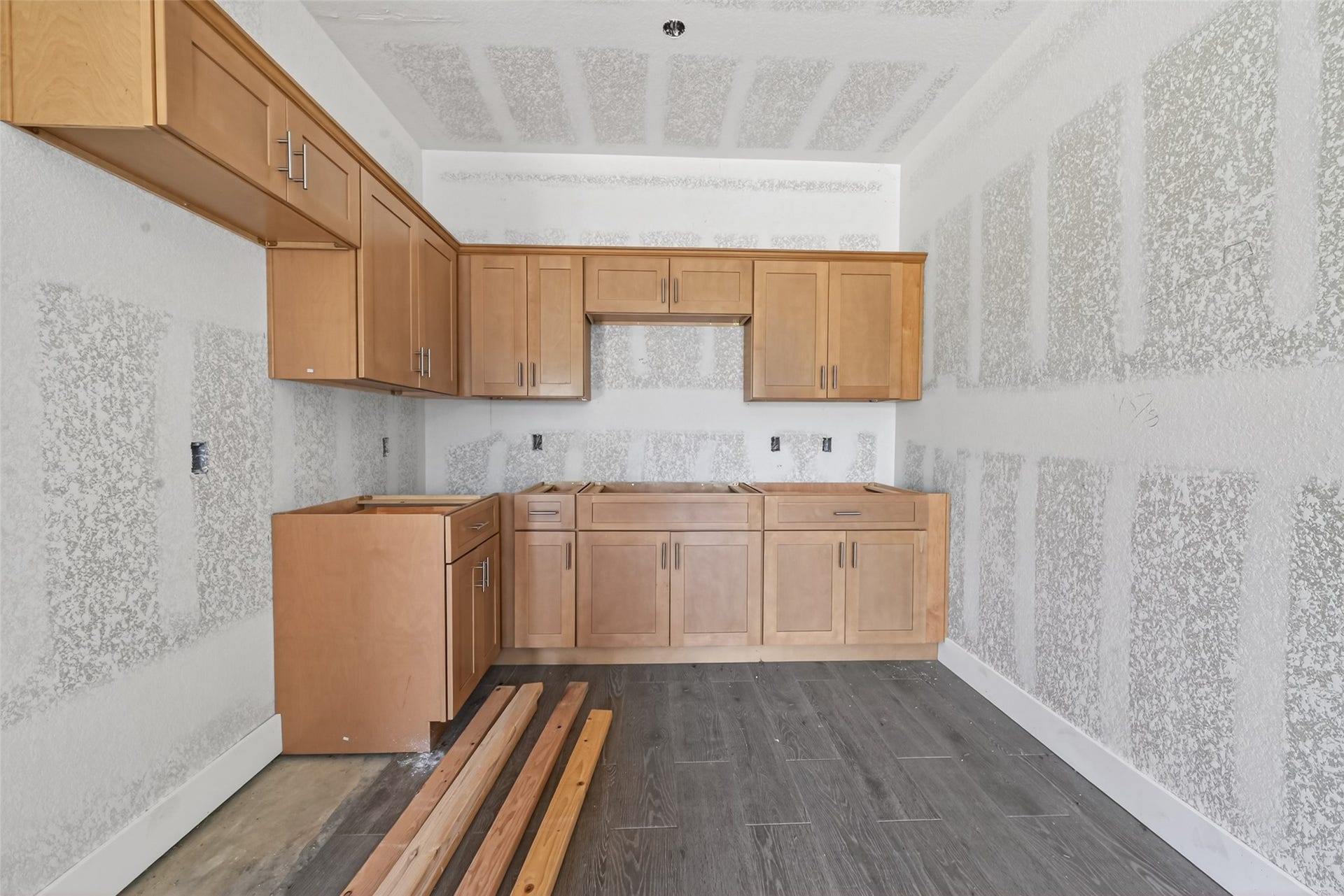 8023 Pool Hill Road, Fulshear, TX 77441 Main-level kitchen area with cabinetry installed and construction in progress.