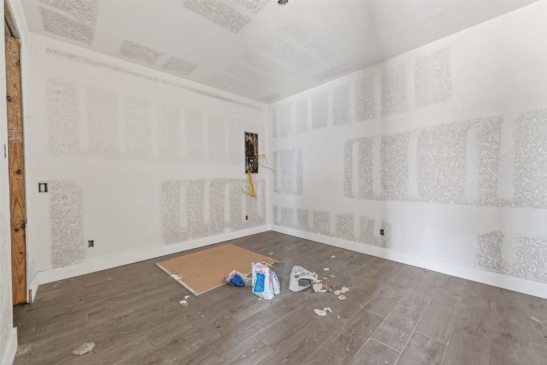 8023 Pool Hill Road, Fulshear, TX 77441 Main-level unfinished interior featuring exposed drywall and construction in progress.