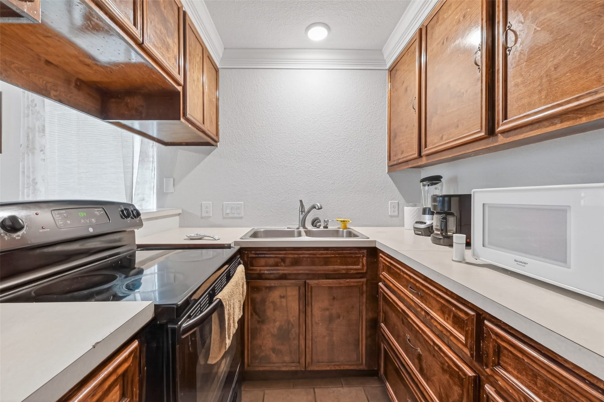 8023 Pool Hill Road, Fulshear, TX 77441 Second-level kitchen featuring wood cabinetry, generous counter space, and efficient layout.