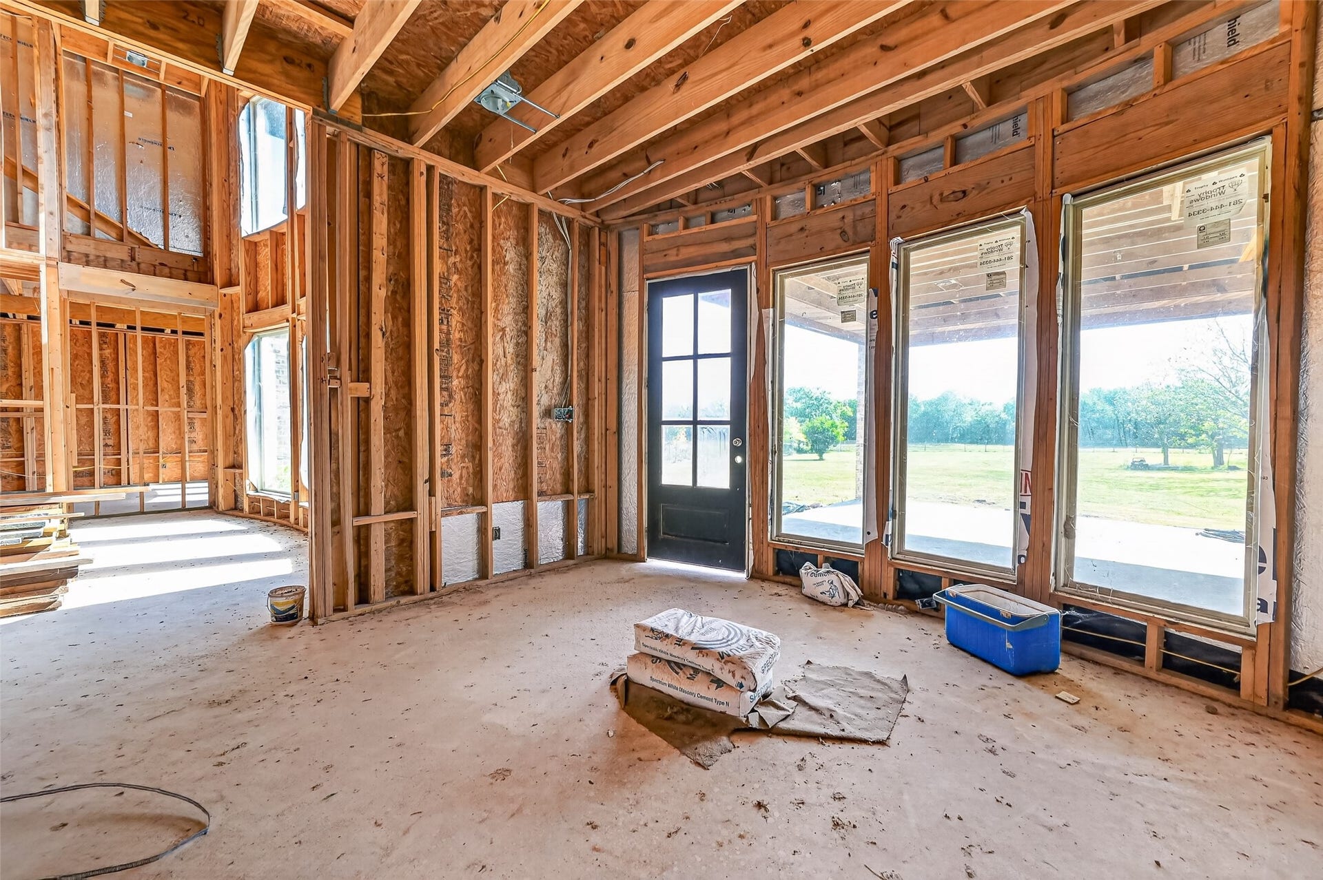 8023 Pool Hill Road, Fulshear, TX 77441 Open unfinished space showcasing framing and build progress.