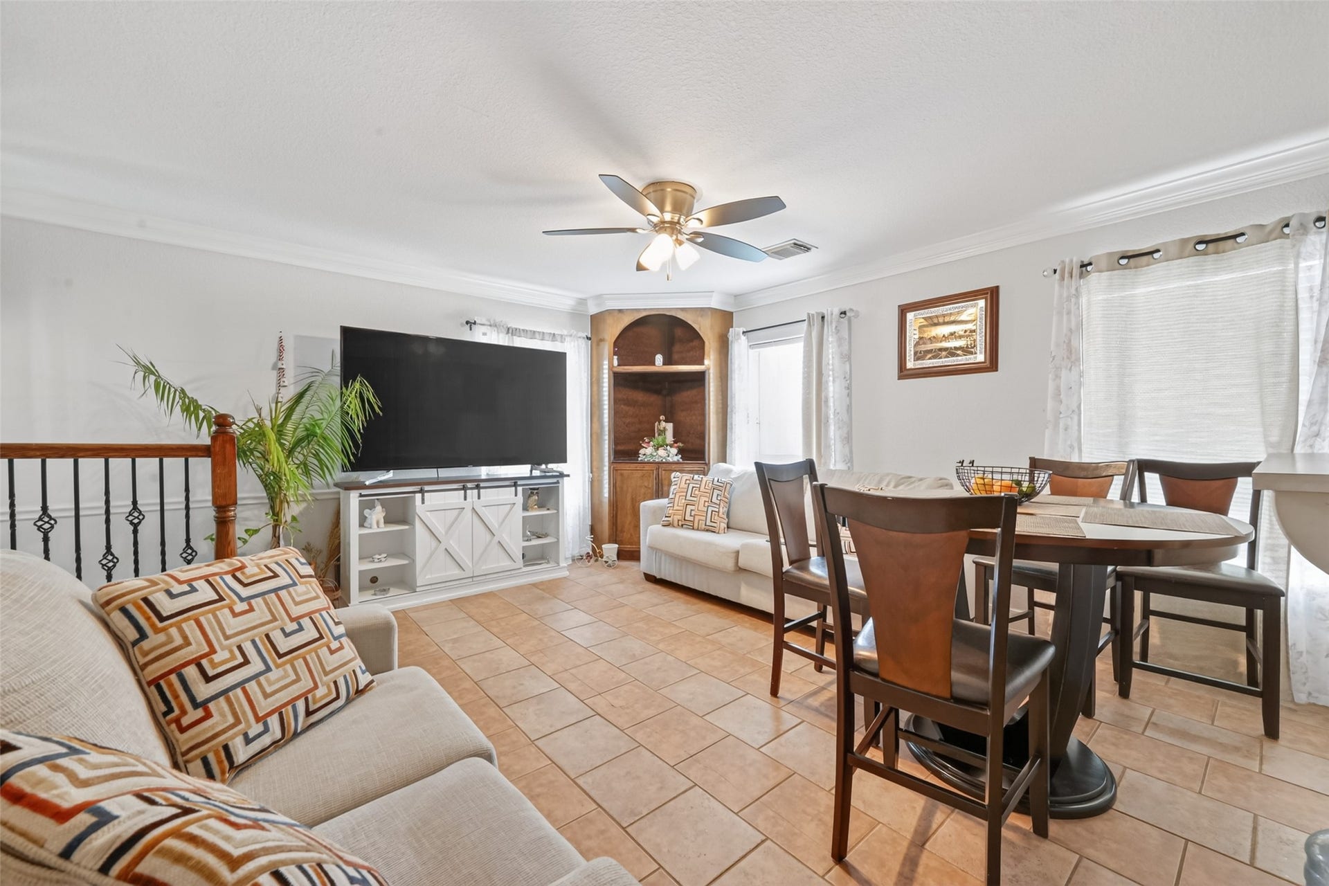8023 Pool Hill Road, Fulshear, TX 77441 Second-level living and dining area with open layout, ceiling fan, and abundant natural light.