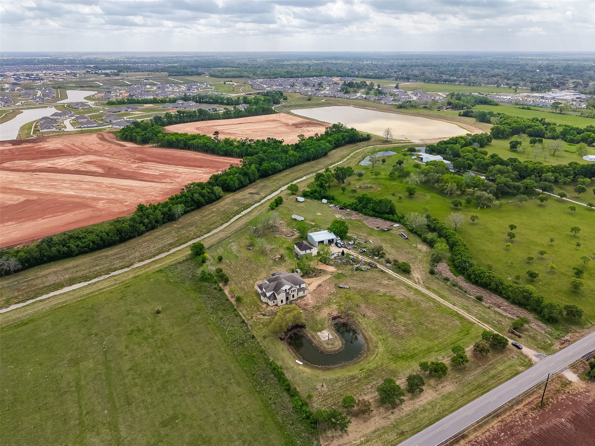 8023 Pool Hill Road, Fulshear, TX 77441 Elevated aerial overview highlighting the full property layout and surrounding farmland.