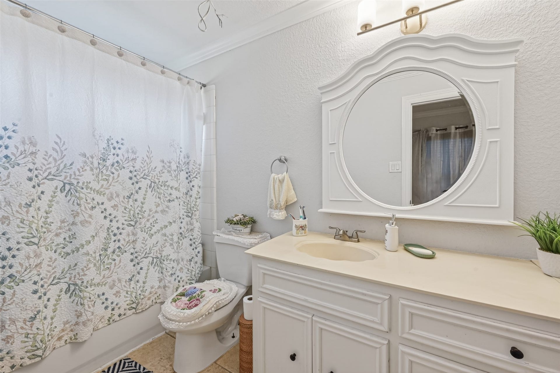 8023 Pool Hill Road, Fulshear, TX 77441 Second-level full bath featuring extended vanity, framed mirror, and shower-tub combination.