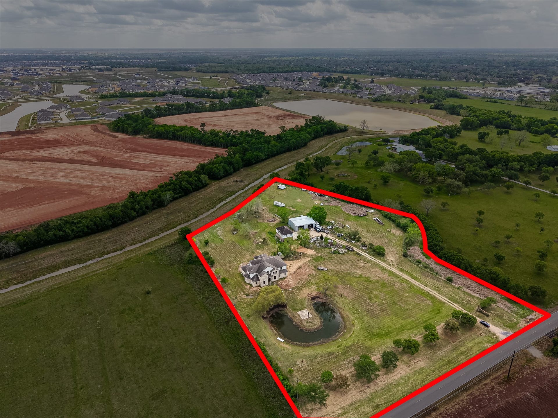 8023 Pool Hill Road, Fulshear, TX 77441 Aerial view of the property with outlined boundaries, multiple structures, and expansive rural surroundings.