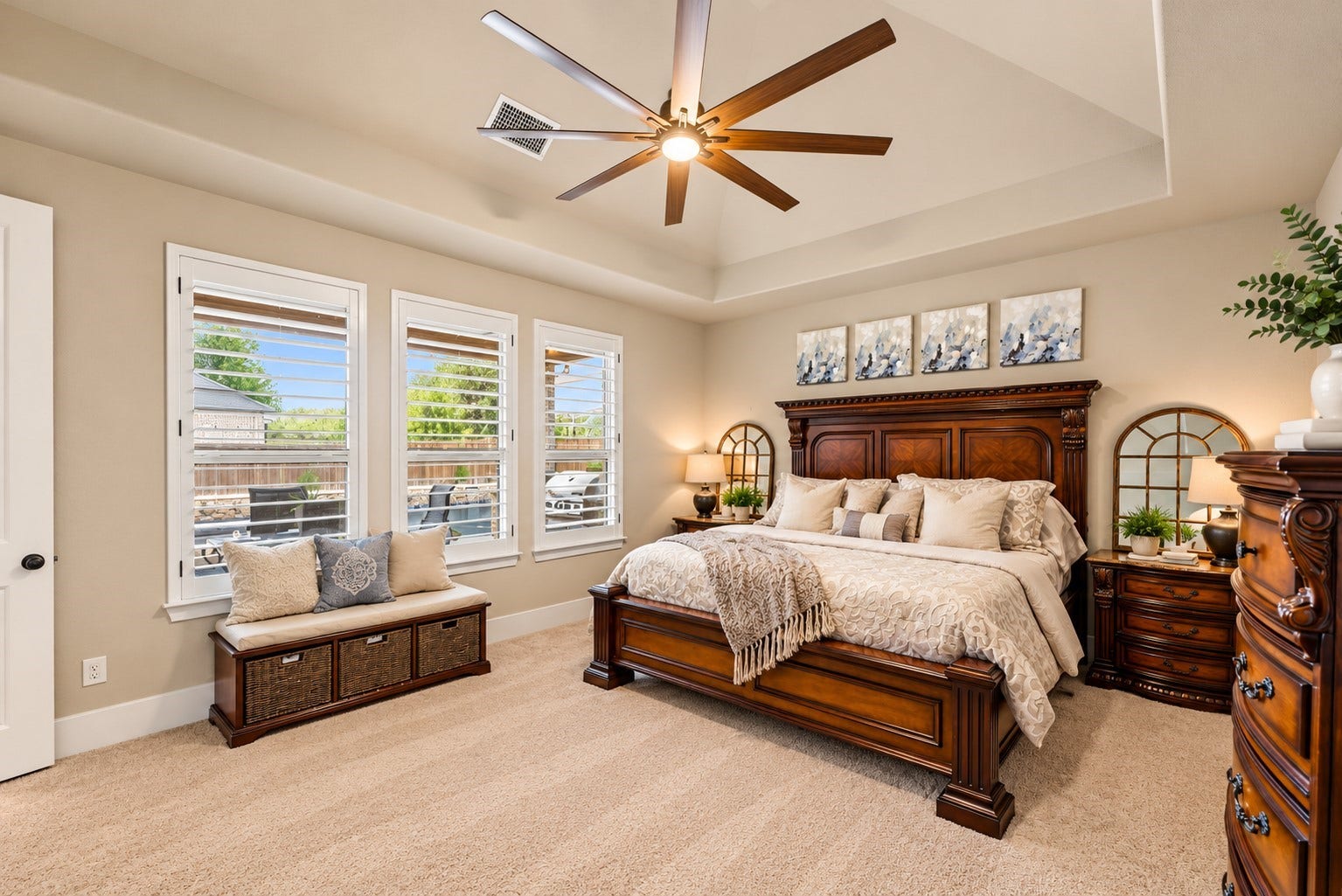 Beautiful primary bedroom with abundant natural light, plantation shutters, and plenty of space for comfortable seating.