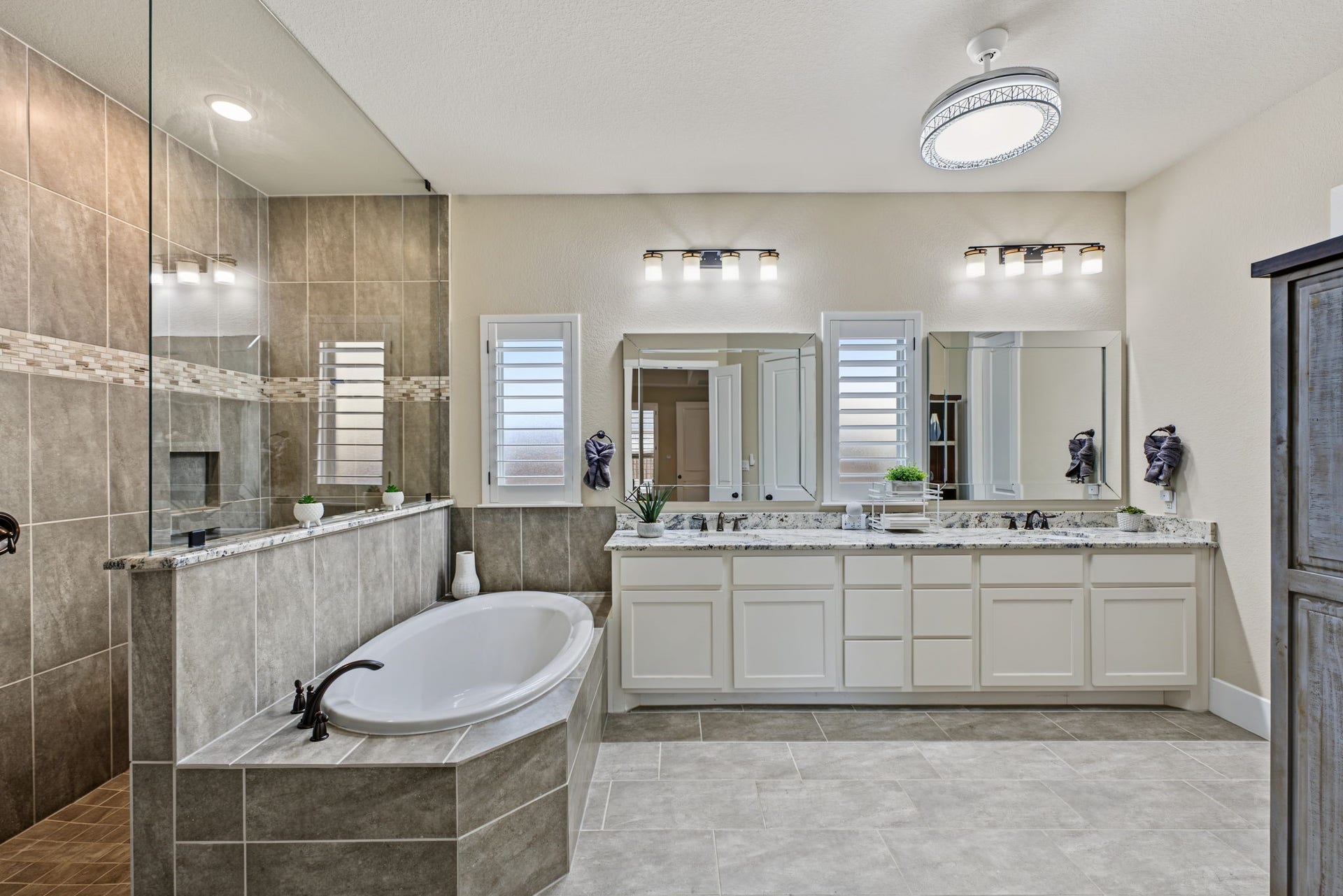 Spa-Inspired Primary Bathroom! Featuring a spacious soaking tub, dual vanities, granite countertops, and an oversized walk-in shower.