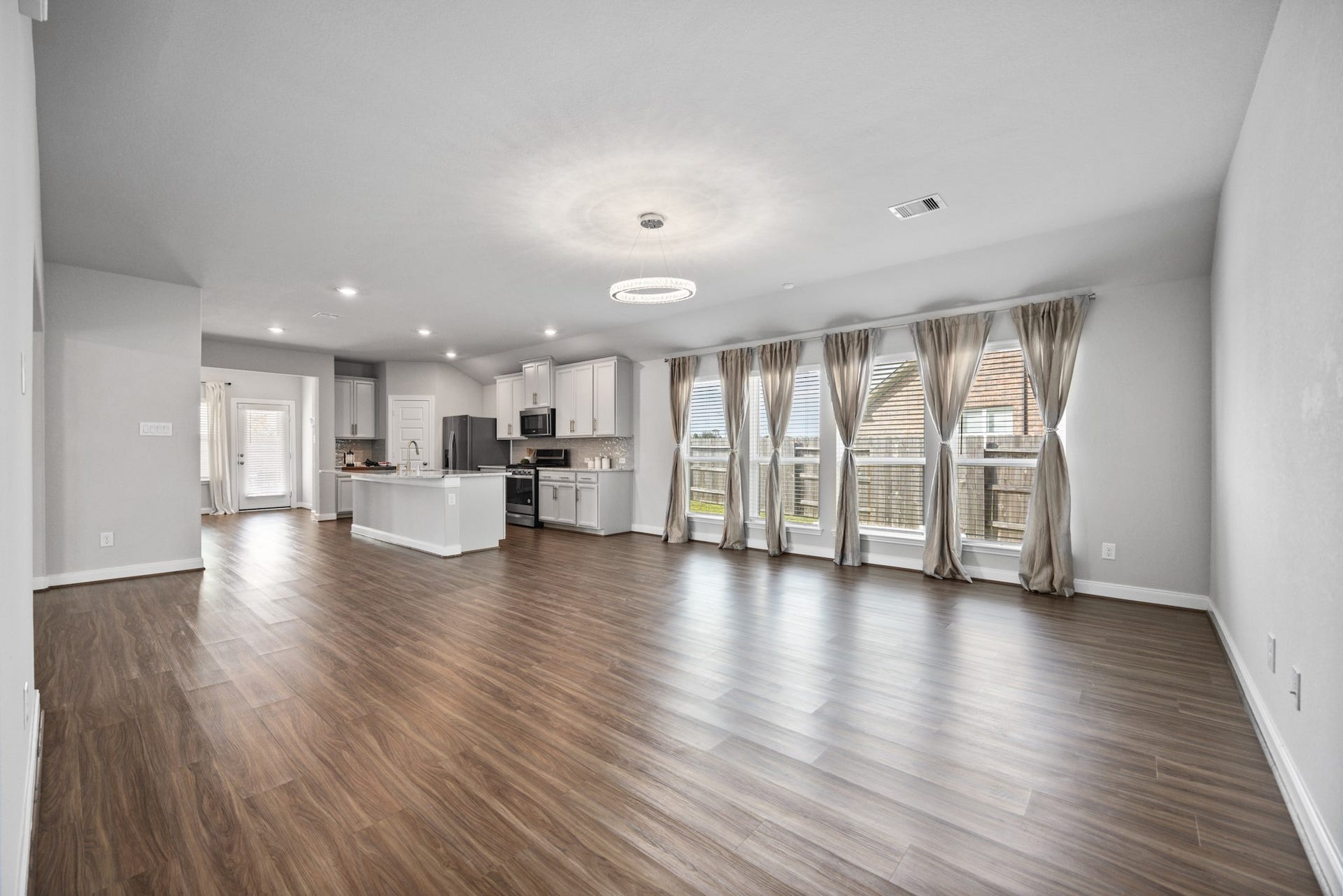 11403 Brookside Arbor Lane, Richmond, TX 77406 Step into an invitingly bright, open-concept living room draped in tasteful vinyl plank floors.