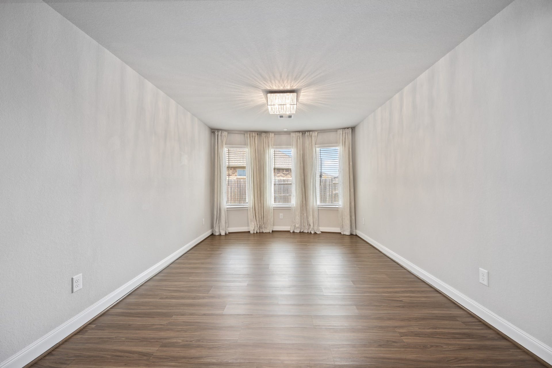 11403 Brookside Arbor Lane, Richmond, TX 77406 Dine in style in this spacious dining room, bathed in natural light from bay windows with neutral curtains and blinds.
